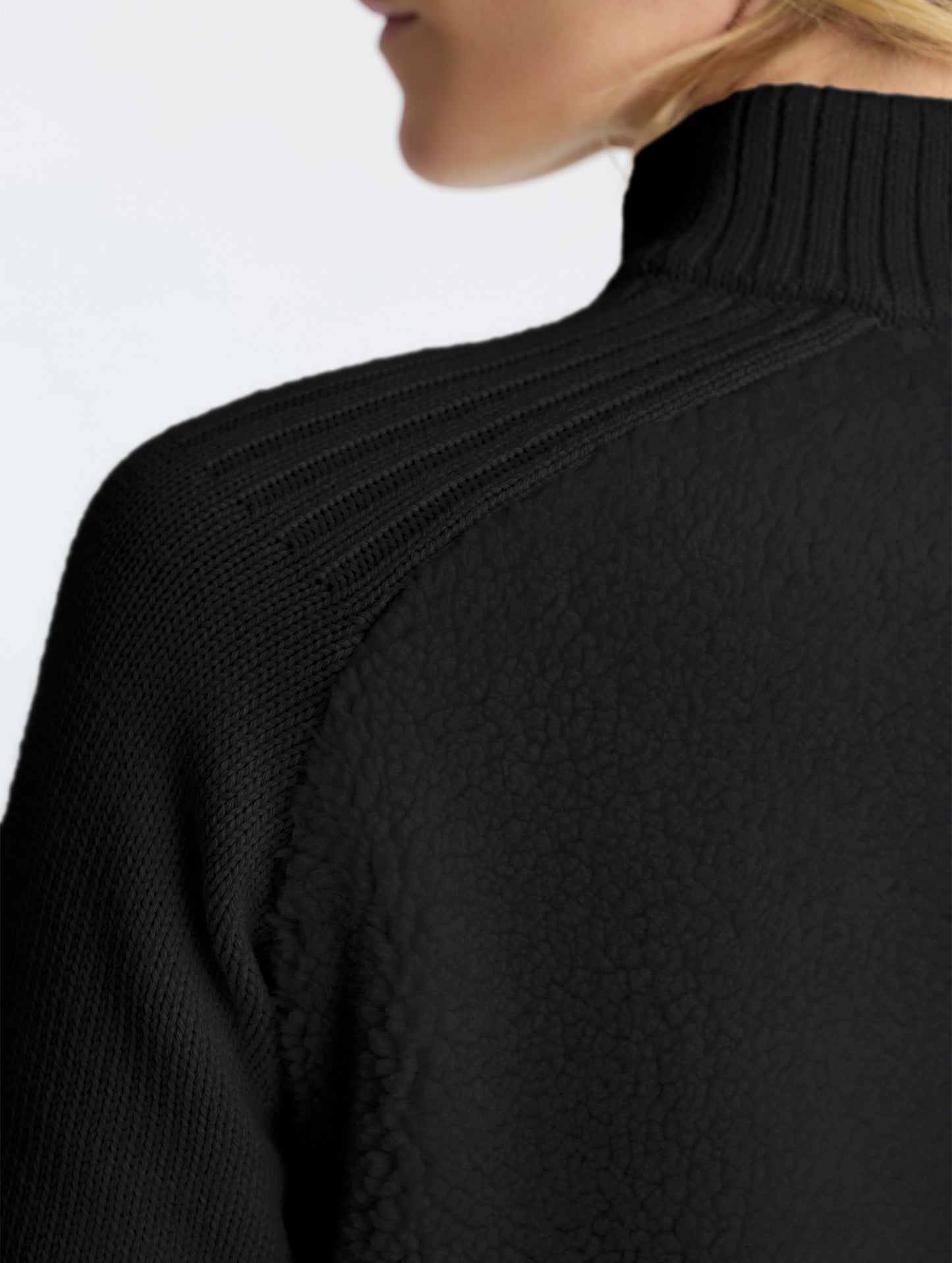Rear closeup view of wearer's left shoulder of Malina Half-Zip Sweater in Onyx Black from AETHER Apparel.