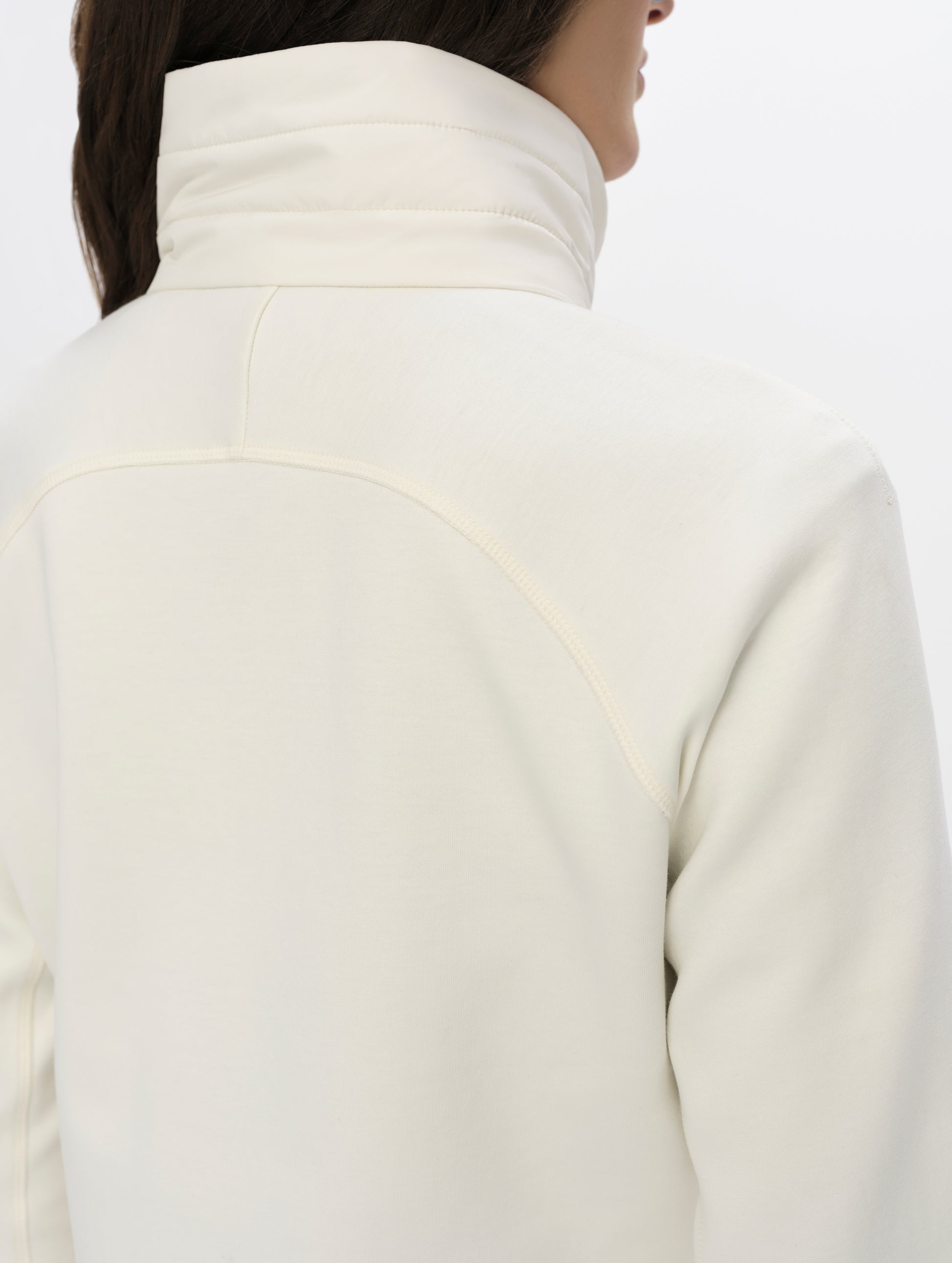 Closeup detailed view of the collar, shoulders, and back of the W Morgan Full-Zip 2.0 in Winter White from AETHER Apparel.