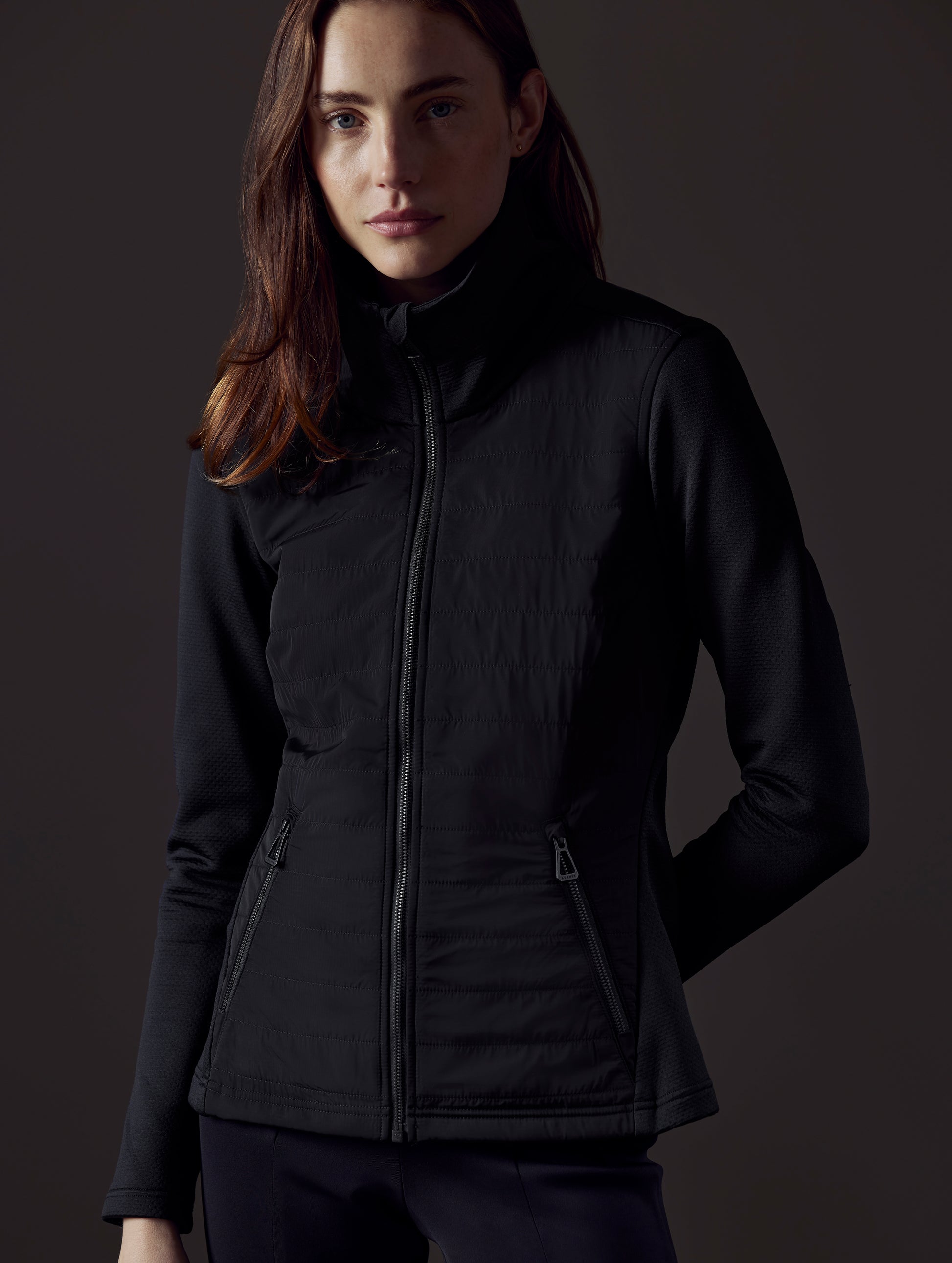 Woman wearing black full-zip from AETHER Apparel