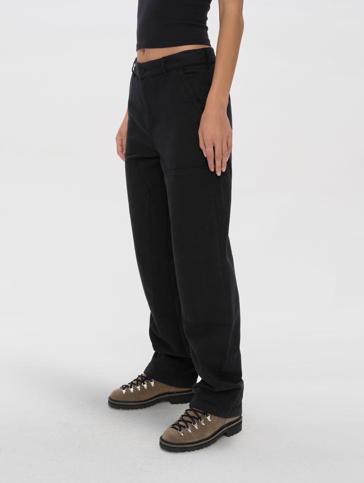 Front angled lower-body view of woman wearing the Natalie Utility Pant in Onyx Black from AETHER Apparel.