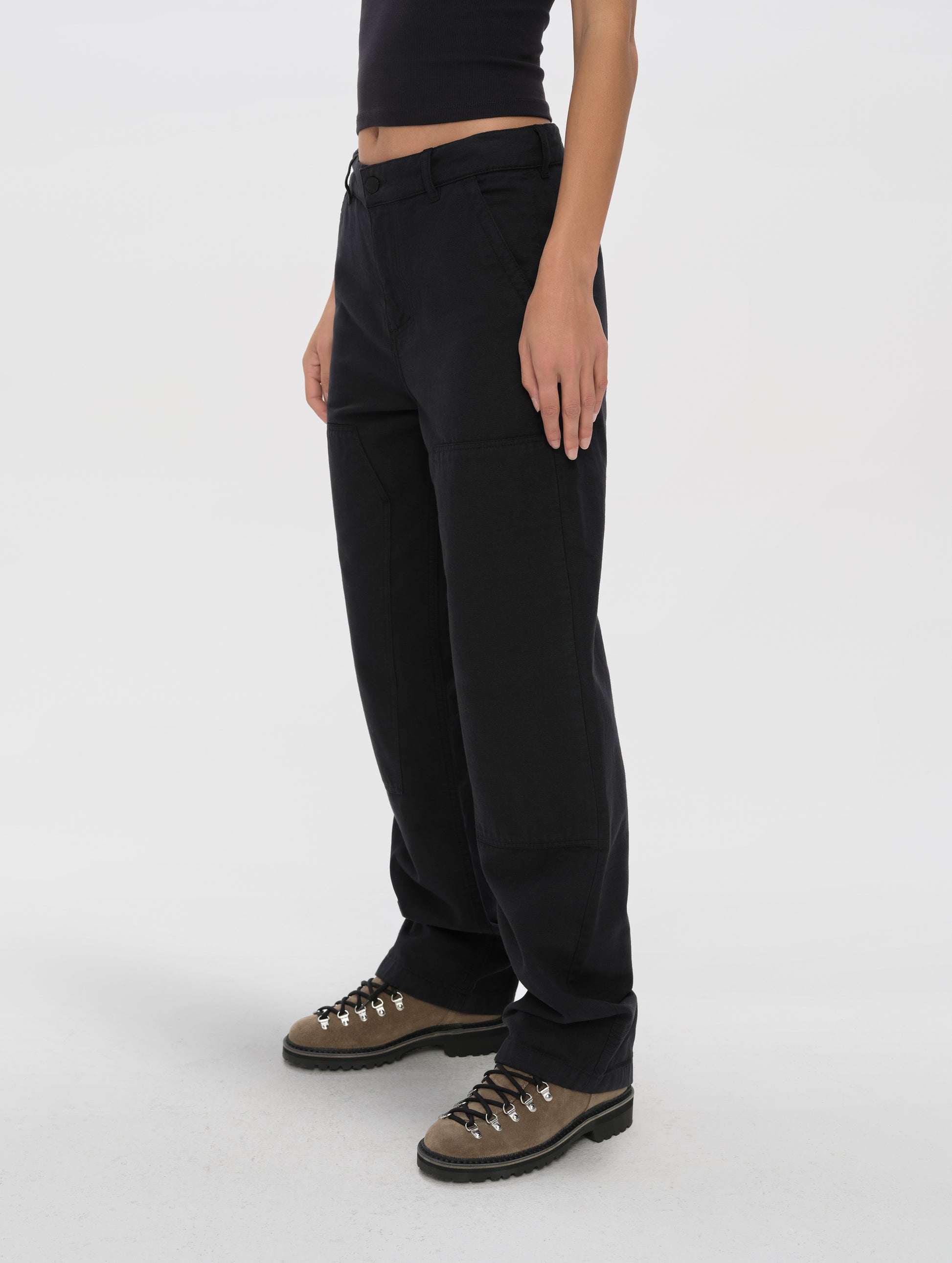 Front angled lower-body view of woman wearing the Natalie Utility Pant in Onyx Black from AETHER Apparel.