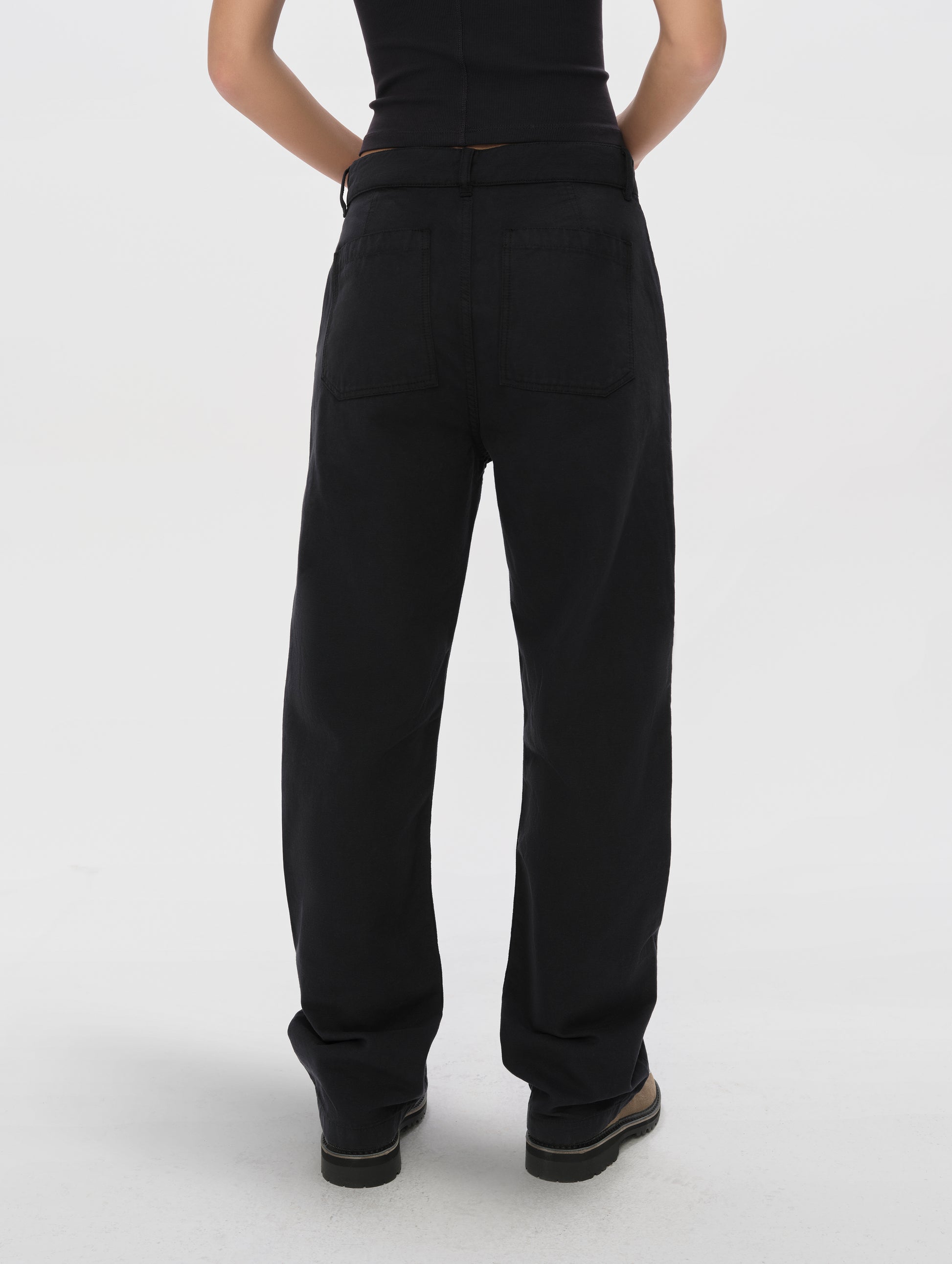 Rear lower-body view of woman wearing the Natalie Utility Pant in Onyx Black from AETHER Apparel.