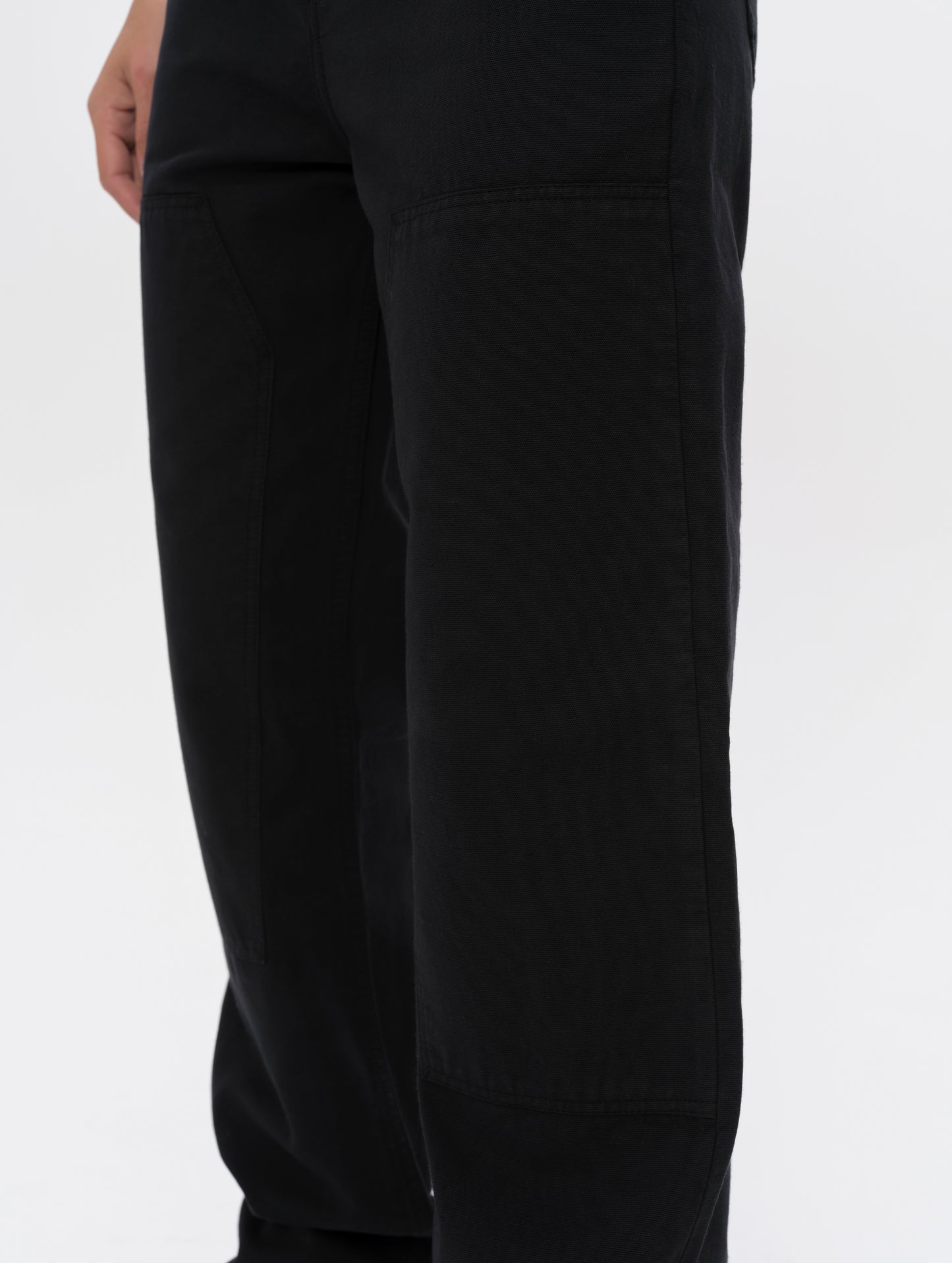 Closeup detailed view of the reinforced dual-layer knee overlays on the Natalie Utility Pant in Onyx Black from AETHER Apparel.
