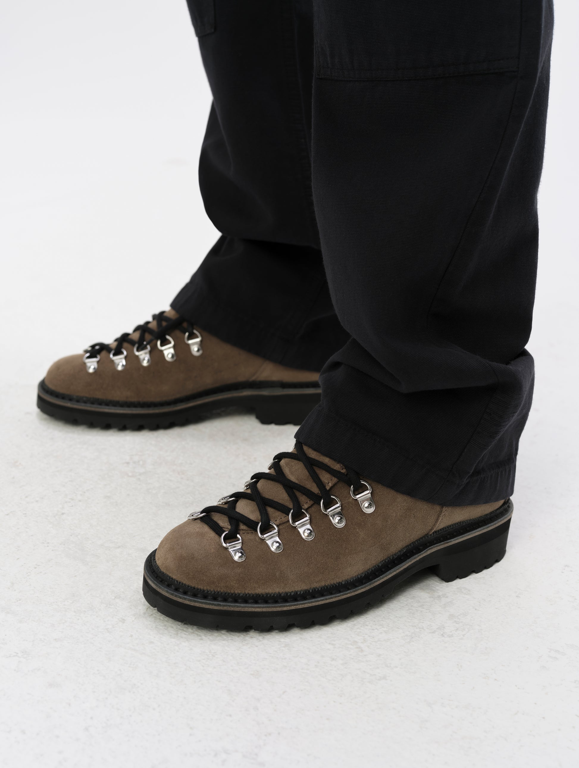 Closeup detailed view of the reinforced leg cuffs on the Natalie Utility Pant in Onyx Black from AETHER Apparel.