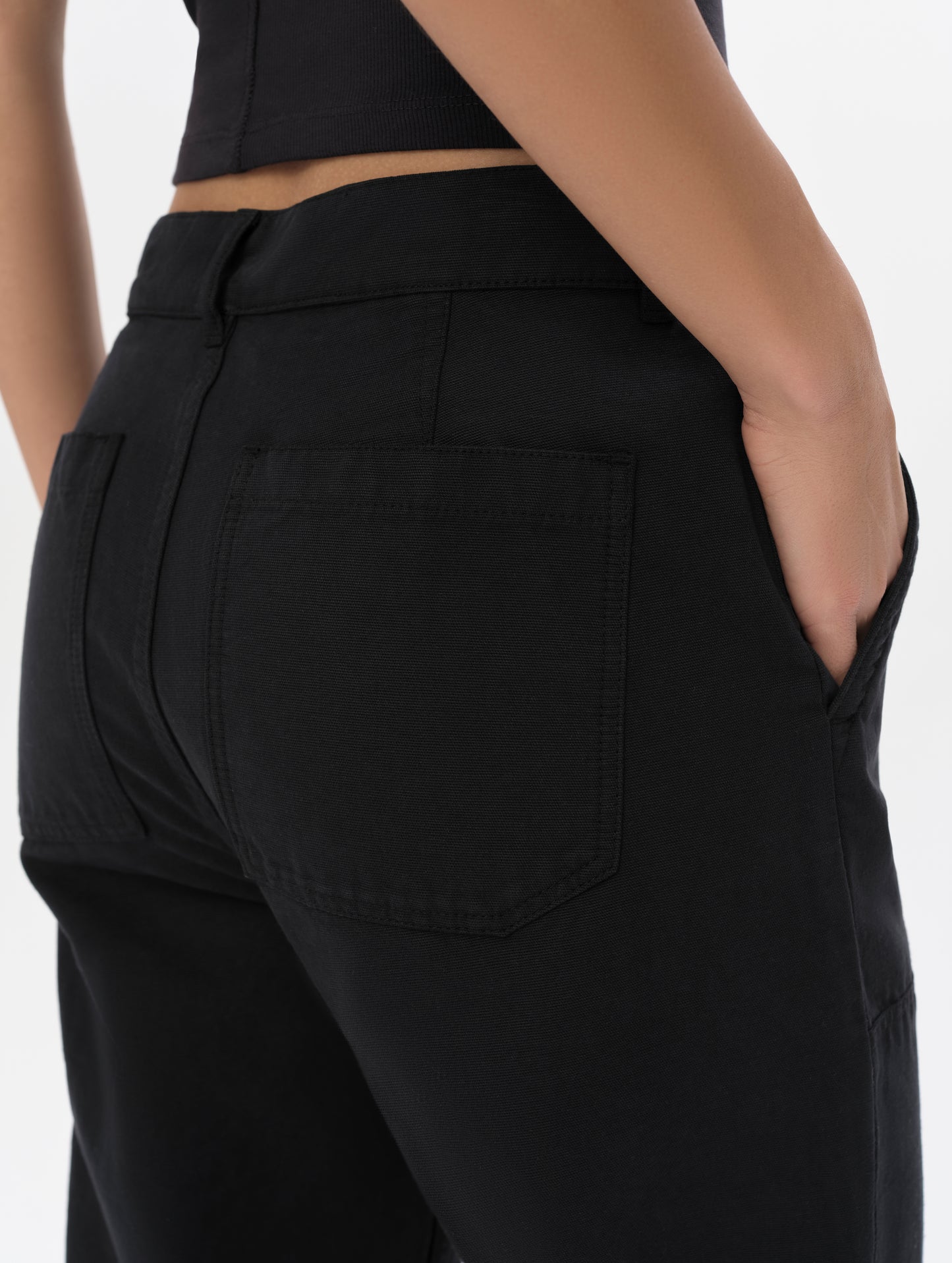 Closeup detailed view of the waistband and back pockets on the Natalie Utility Pant in Onyx Black from AETHER Apparel.