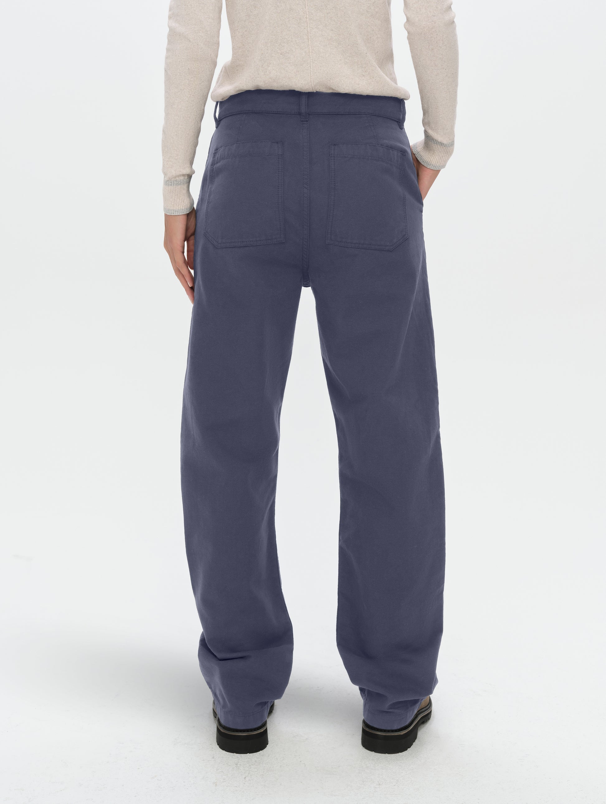 Rear lower-body view of woman wearing the Natalie Utility Pant in Portal Blue from AETHER Apparel.