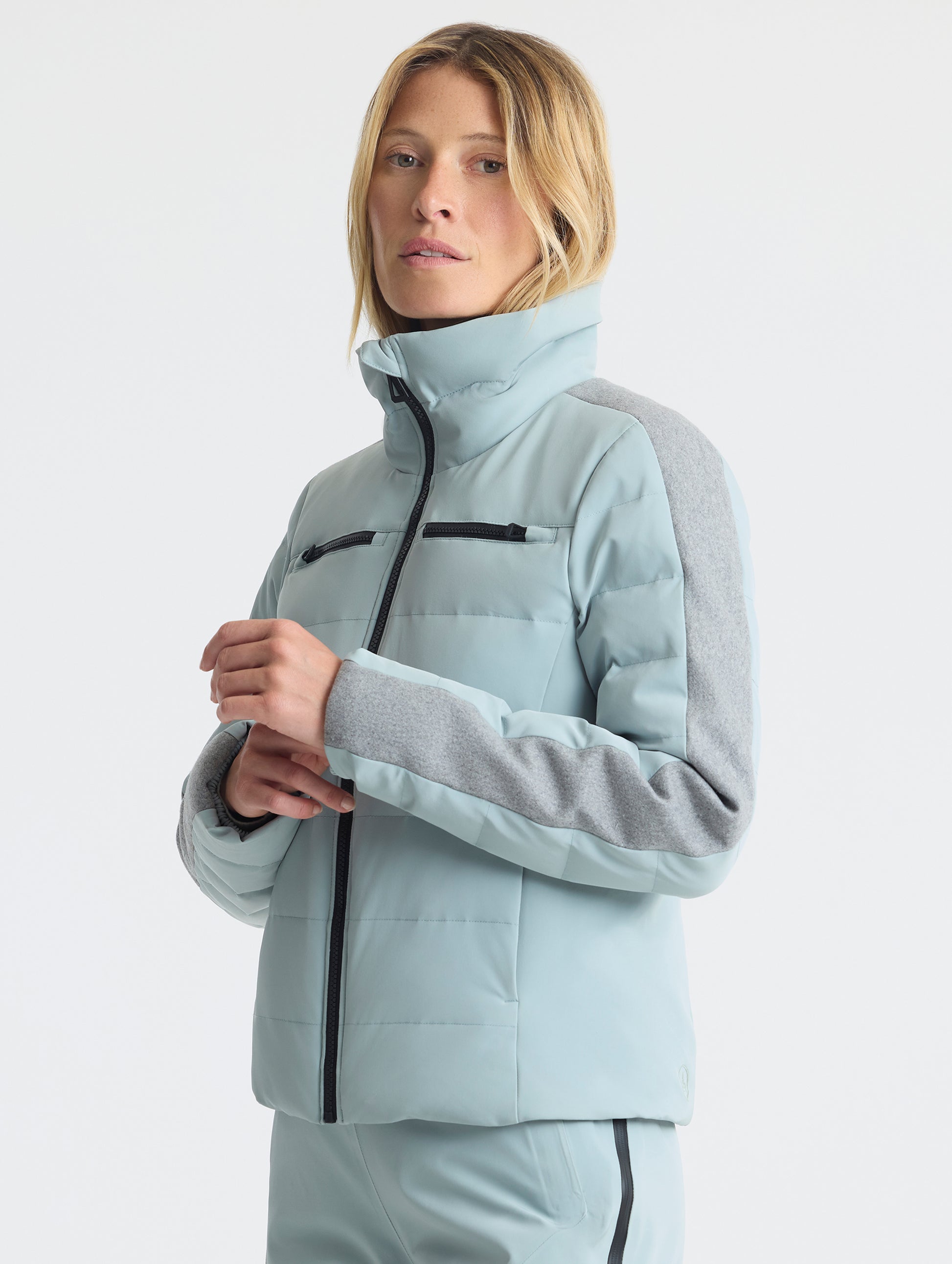 Front angled upper-body view of woman wearing the Nordic Jacket 2.0 in Jadewood Green from AETHER Apparel.