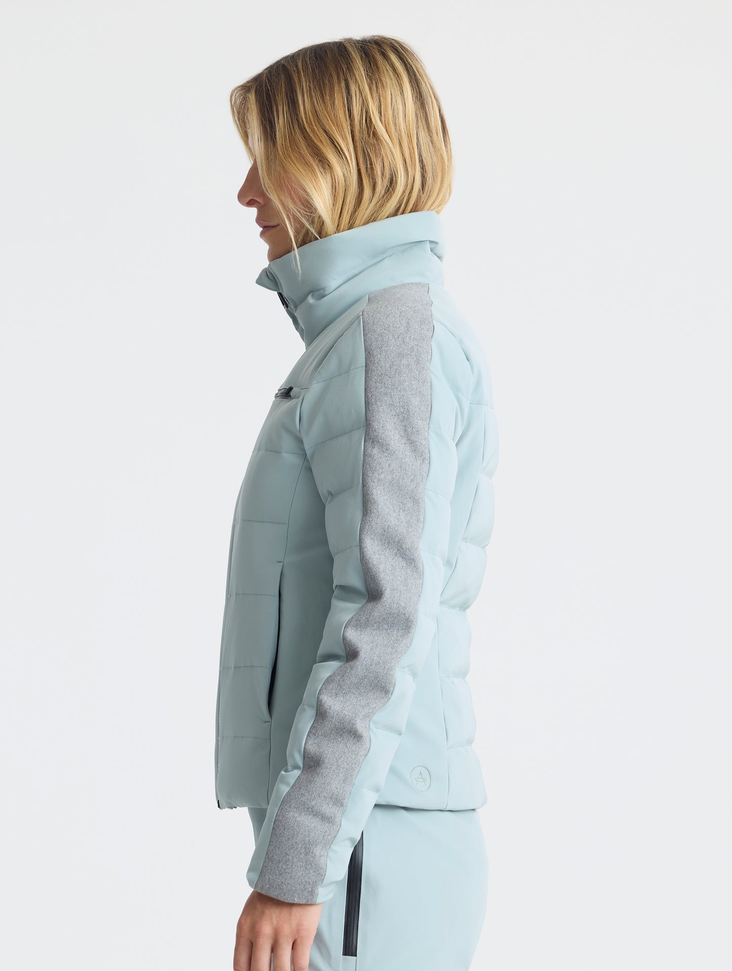 Side profile upper-body view of woman wearing the Nordic Jacket 2.0 in Jadewood Green from AETHER Apparel.