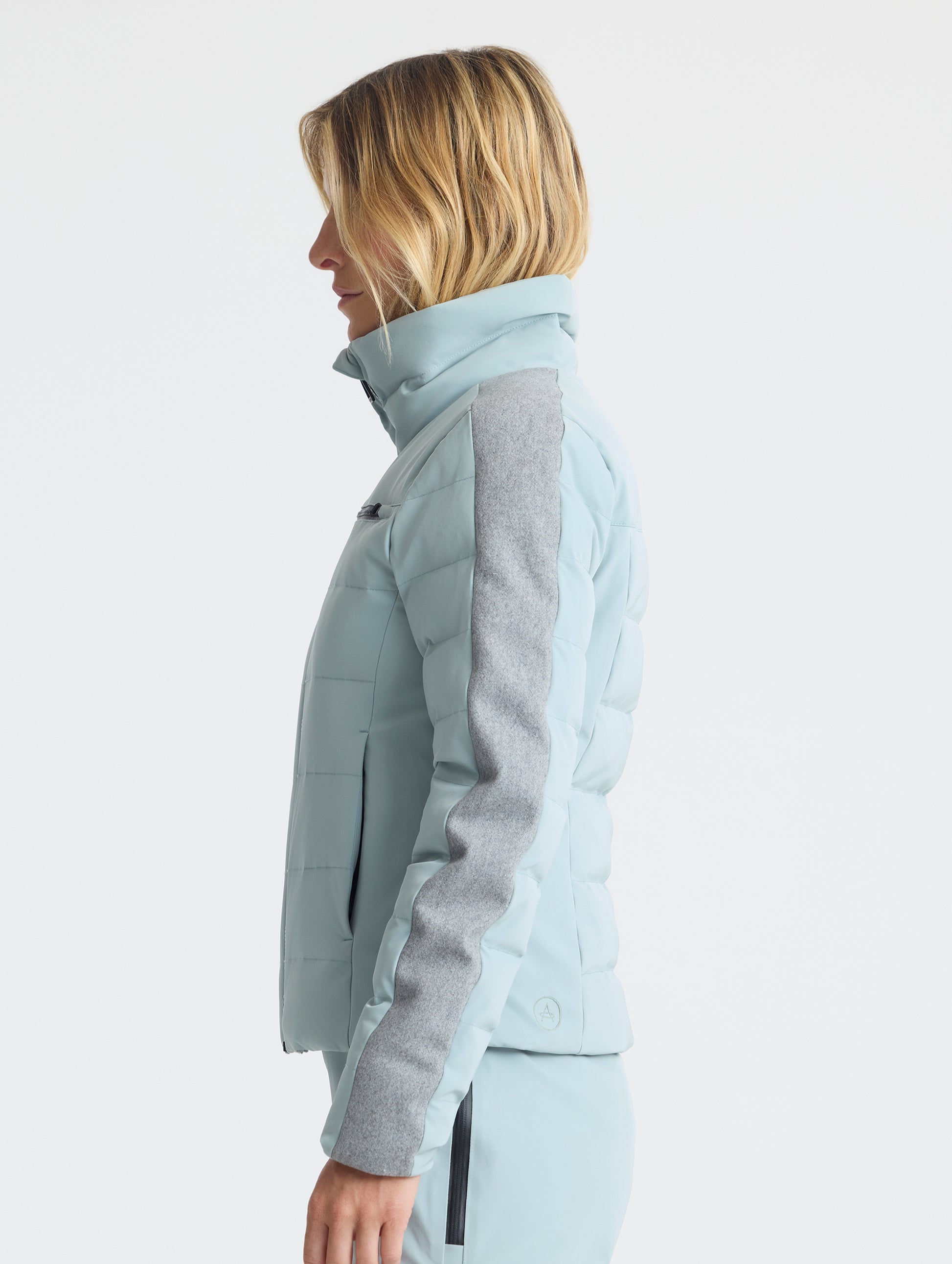 Side profile upper-body view of woman wearing the Nordic Jacket 2.0 in Jadewood Green from AETHER Apparel.