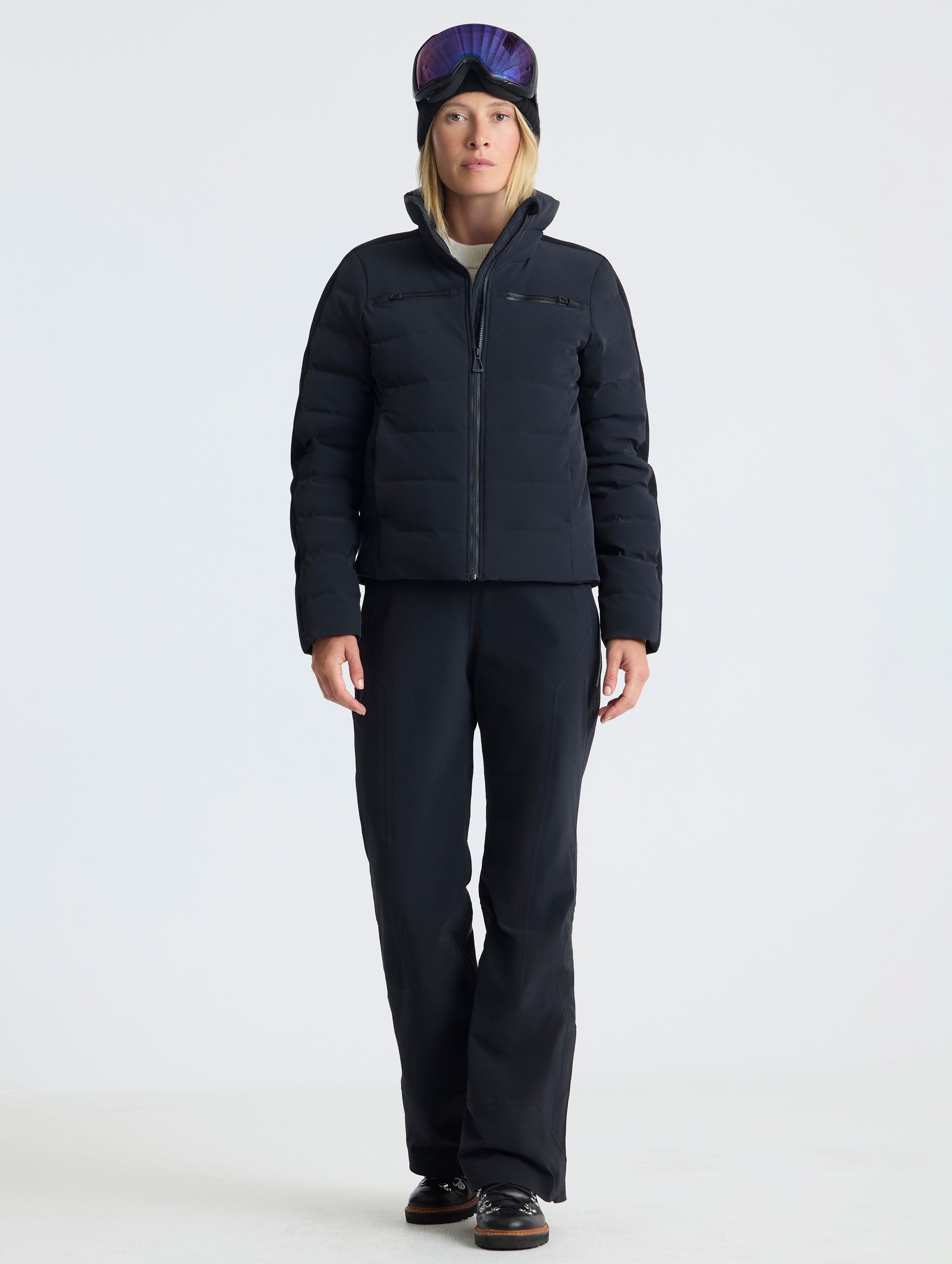 Front full-body view of woman wearing zipped-up Nordic Jacket 2.0 in Onyx Black from AETHER Apparel.