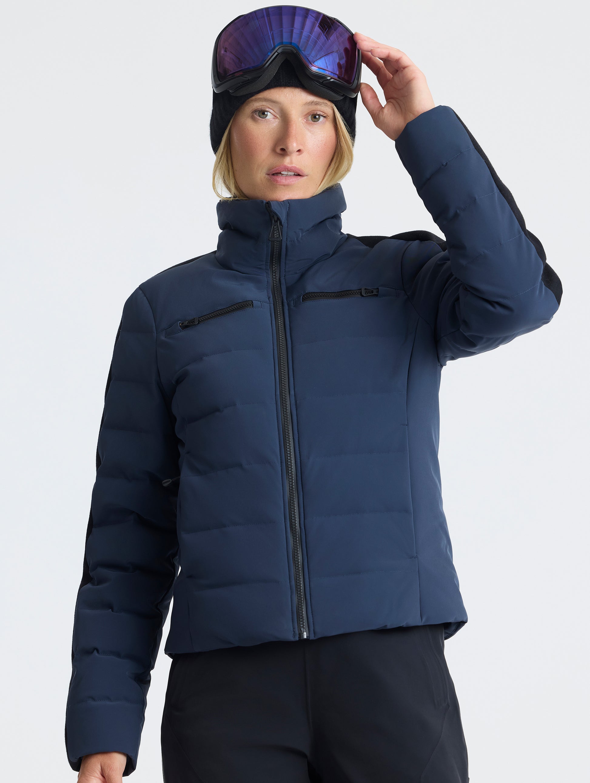 Front upper-body view of woman wearing the Nordic Jacket 2.0 in Total Eclipse dark blue from AETHER Apparel.