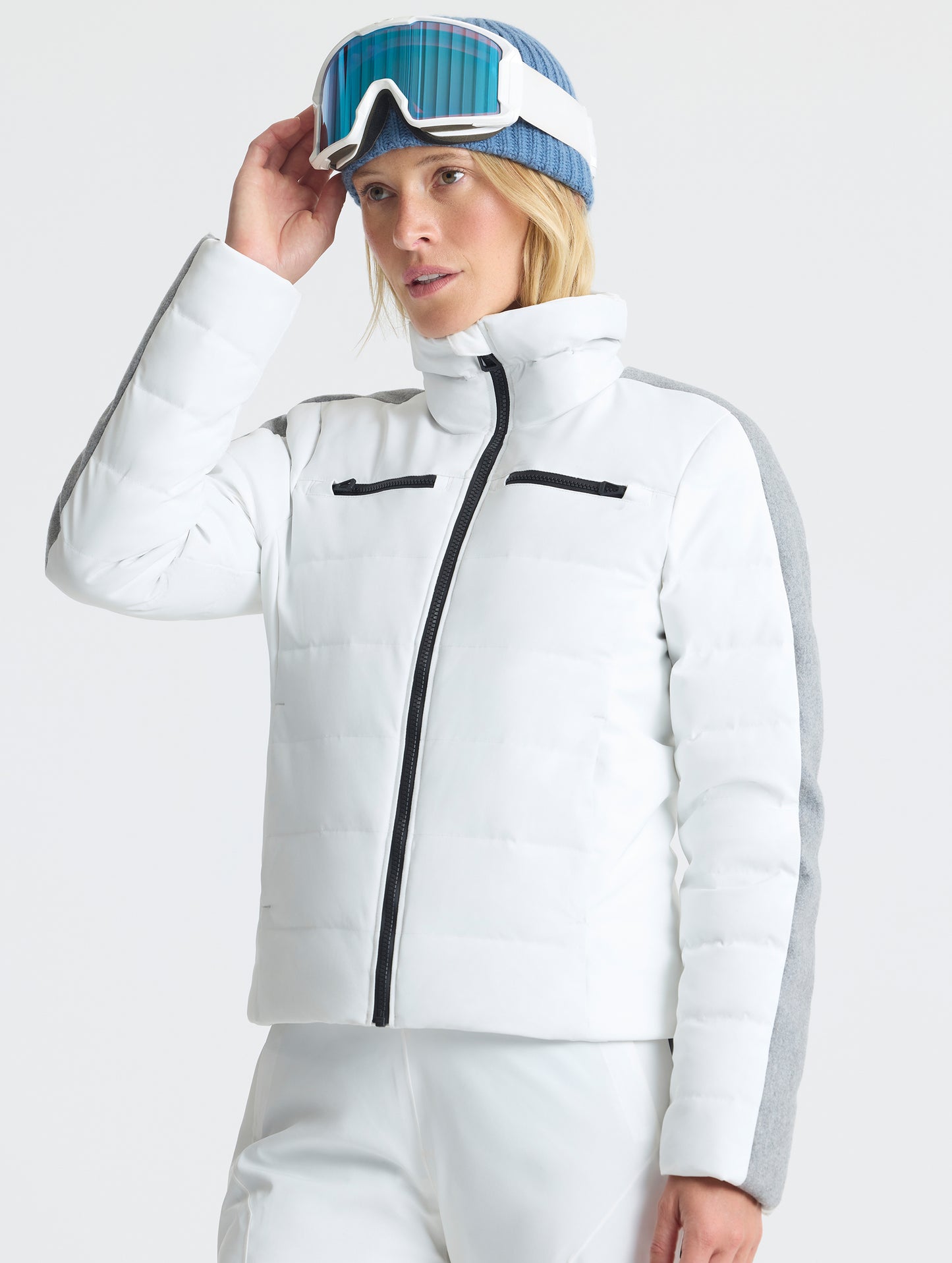 Front angled upper-body view of woman wearing the Nordic Jacket 2.0 in Winter White from AETHER Apparel.