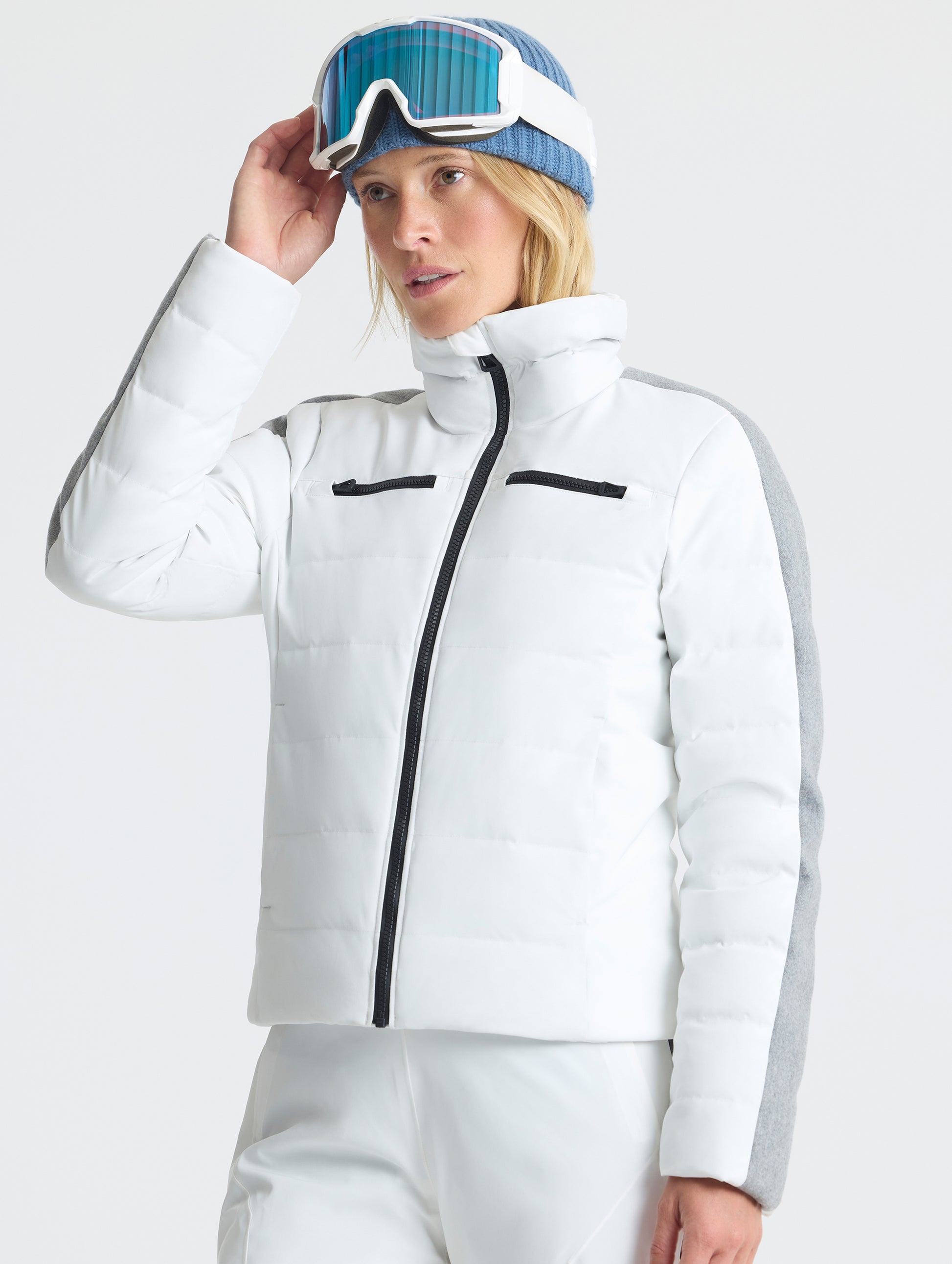 Front angled upper-body view of woman wearing the Nordic Jacket 2.0 in Winter White from AETHER Apparel.