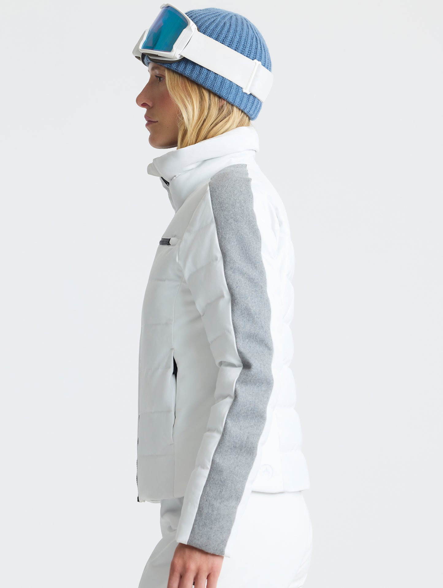 Side profile upper-body view of woman wearing the Nordic Jacket 2.0 in Winter White from AETHER Apparel.