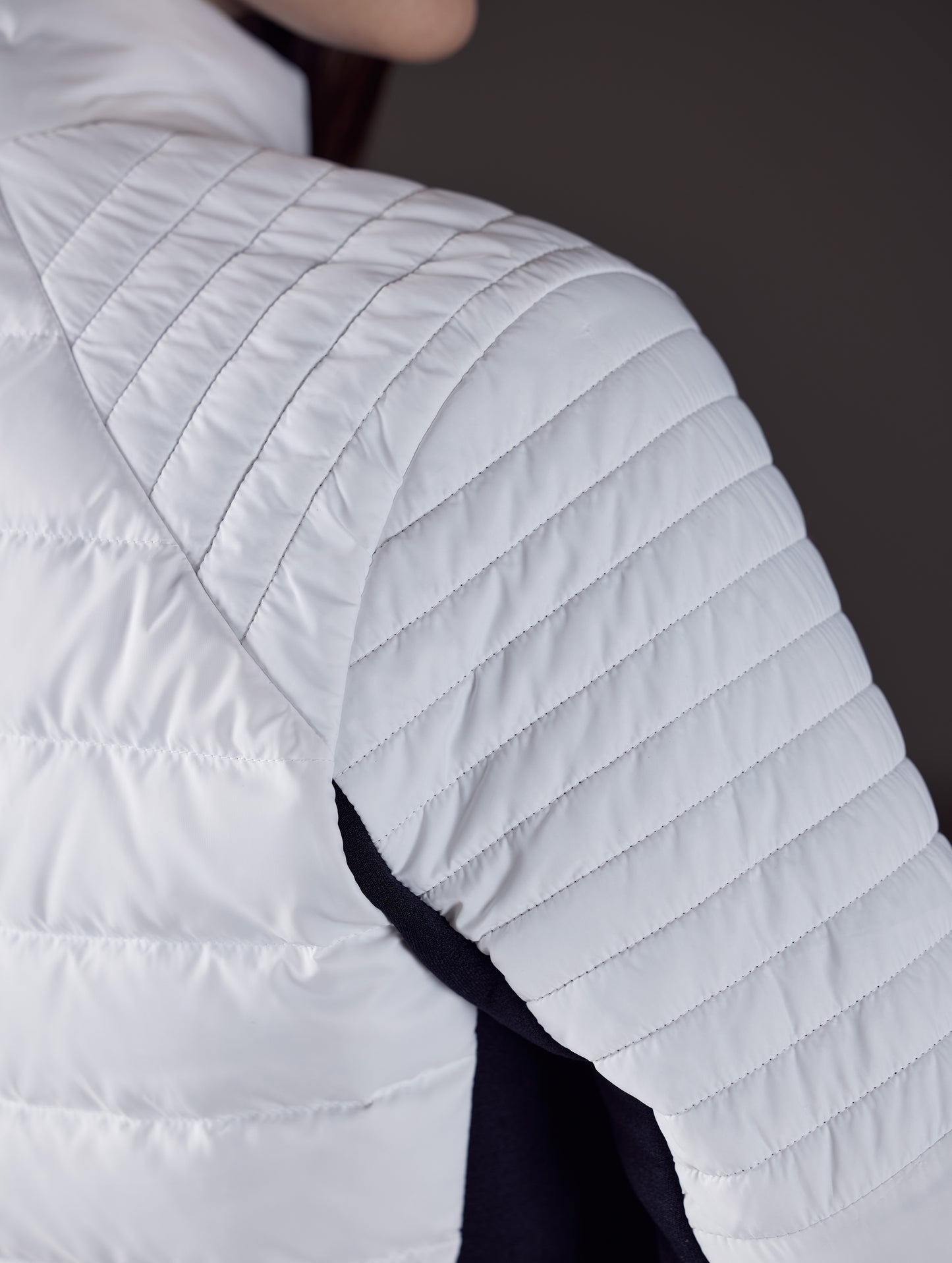 Close view of women's white quilted snow jacket from AETHER Apparel