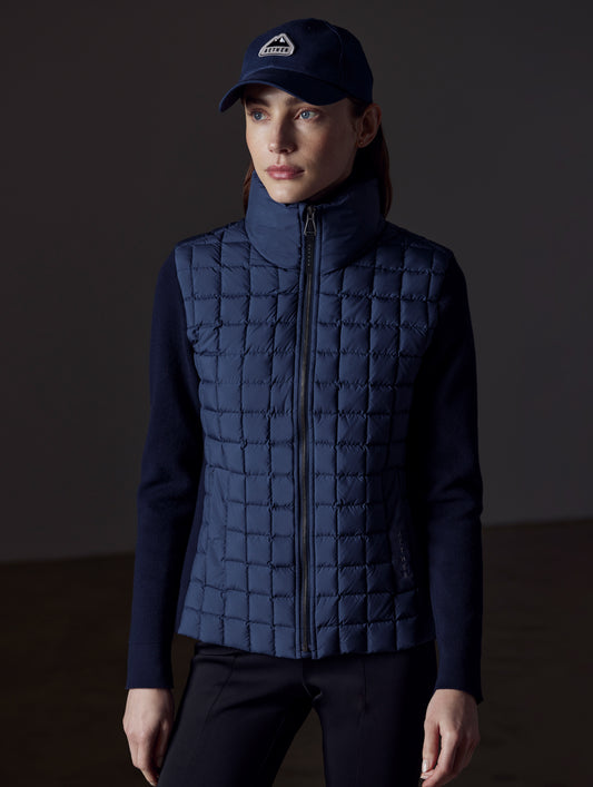 Front view of woman wearing Phase Full-Zip in Total Eclipse dark blue from AETHER Apparel.