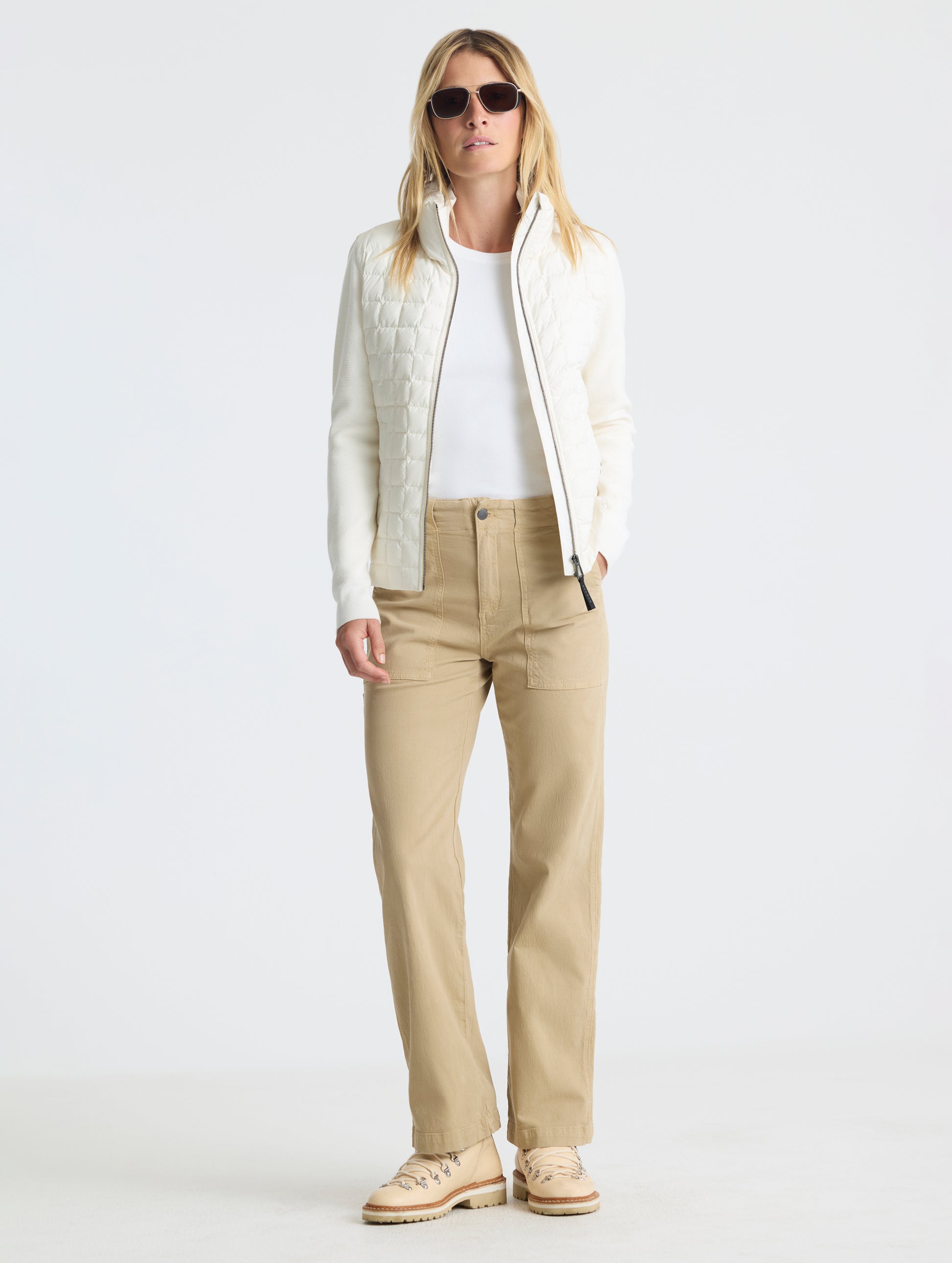 Front full-body view of woman wearing unzipped Phase Full-Zip in Winter White from AETHER Apparel.