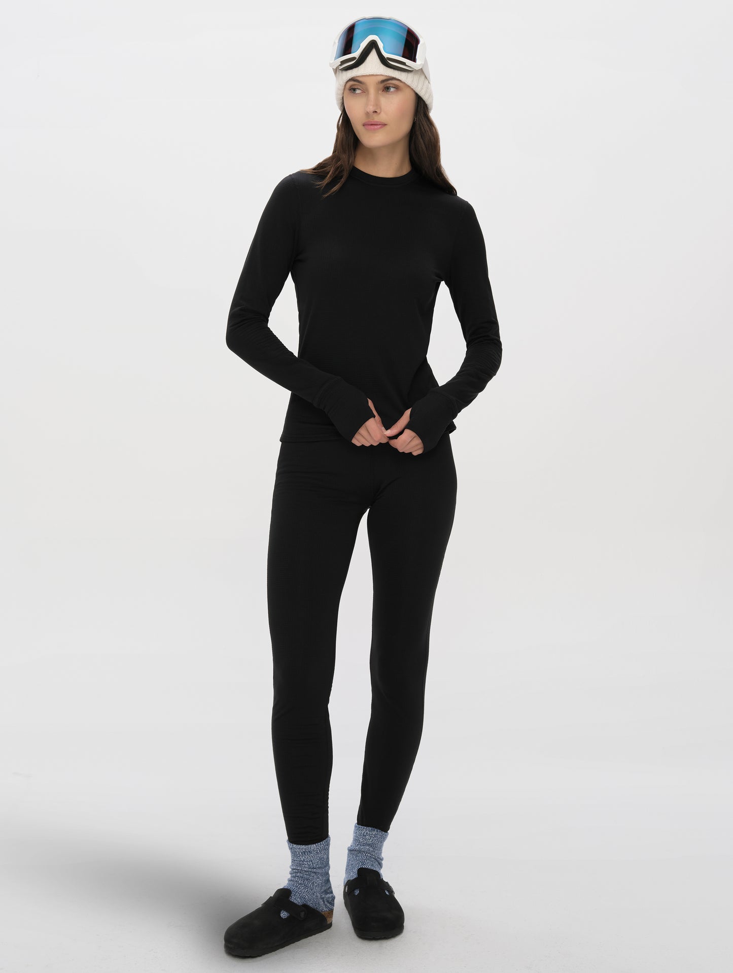 Front full-body view of woman wearing Polar Base Layer Pant in Onyx Black from AETHER Apparel.