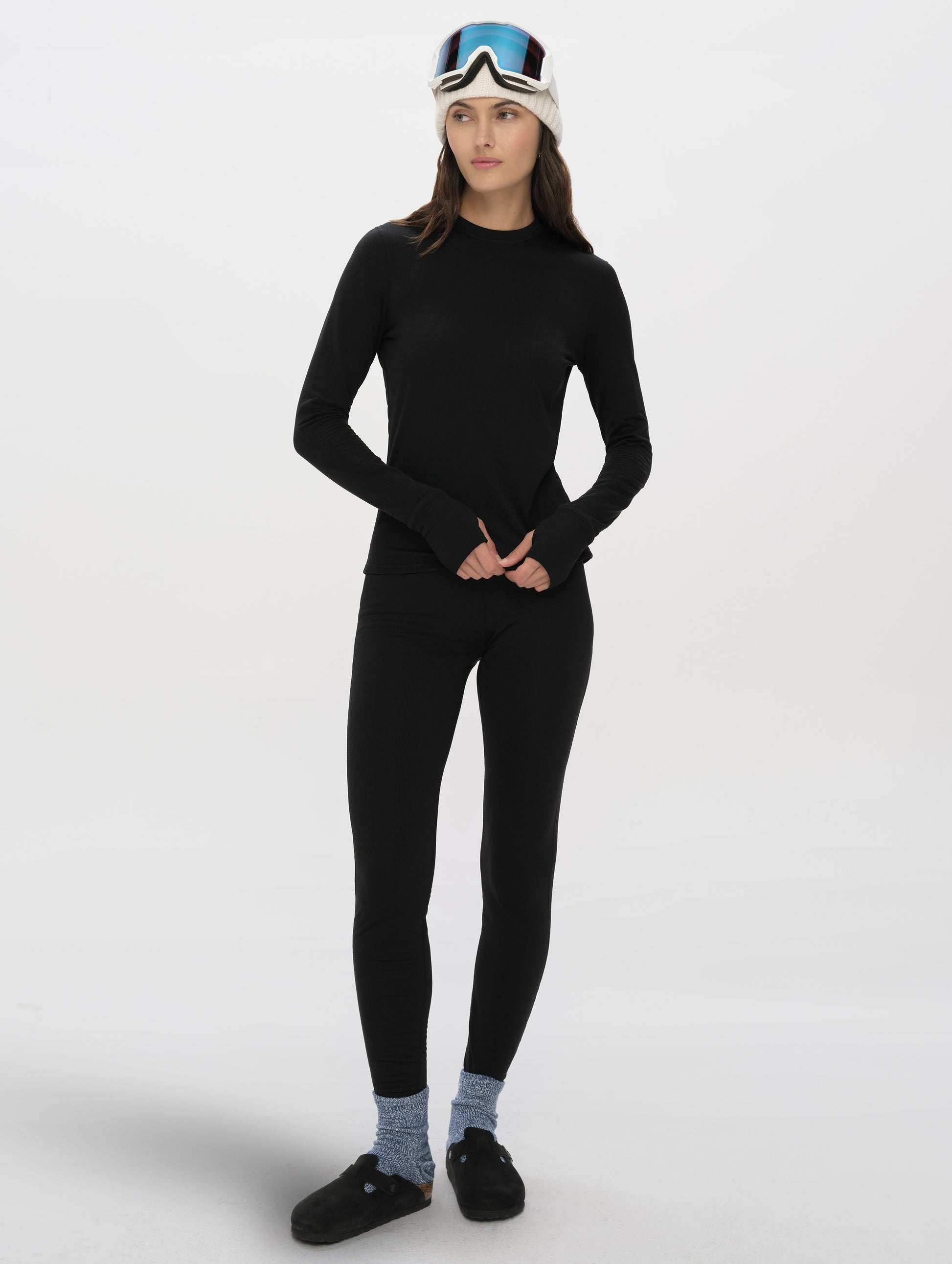 Front full-body view of woman wearing Polar Base Layer Pant in Onyx Black from AETHER Apparel.