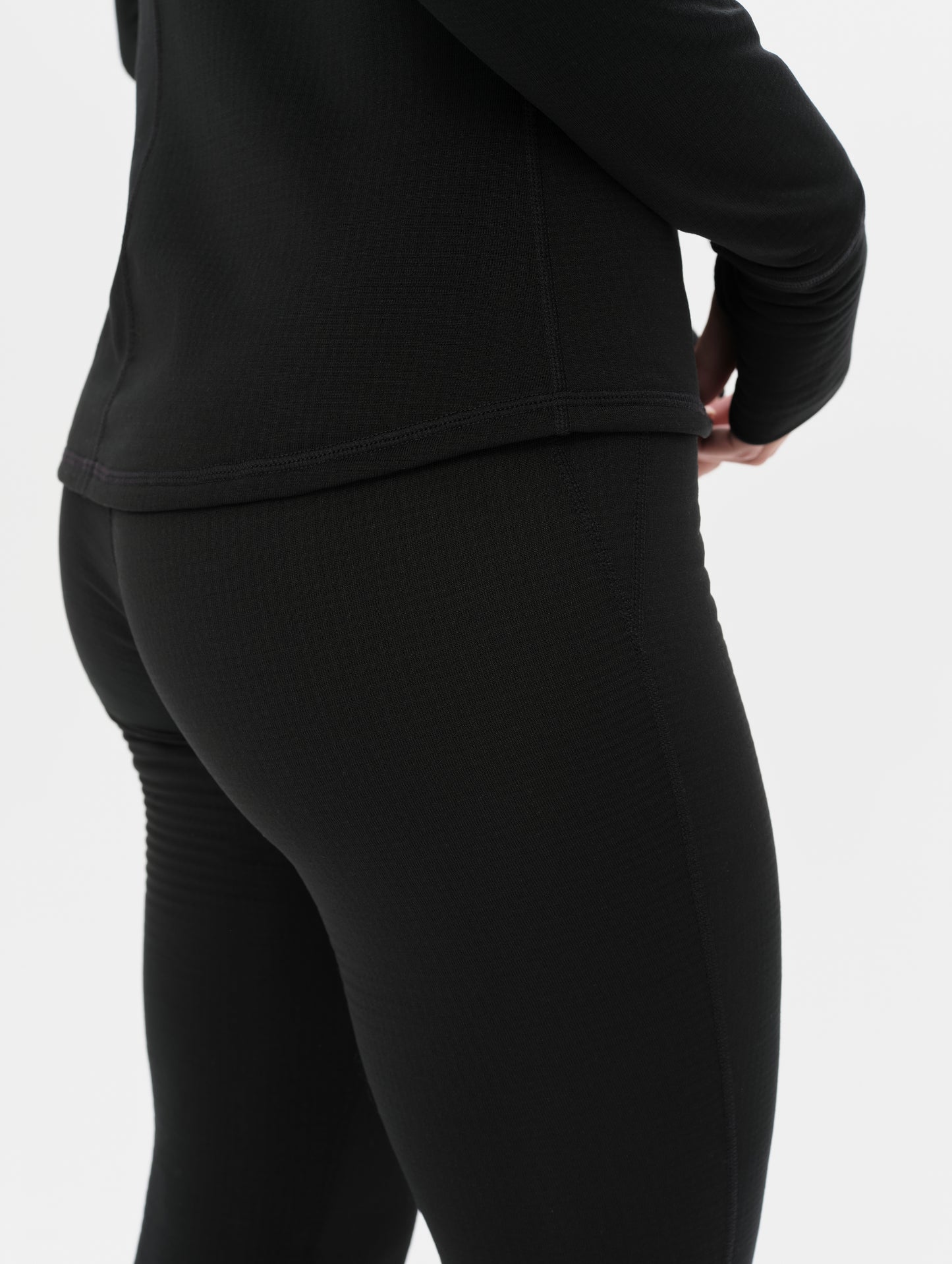 Side profile closeup view of the flat-lock side seams on the Polar Base Layer Pant in Onyx Black from AETHER Apparel.