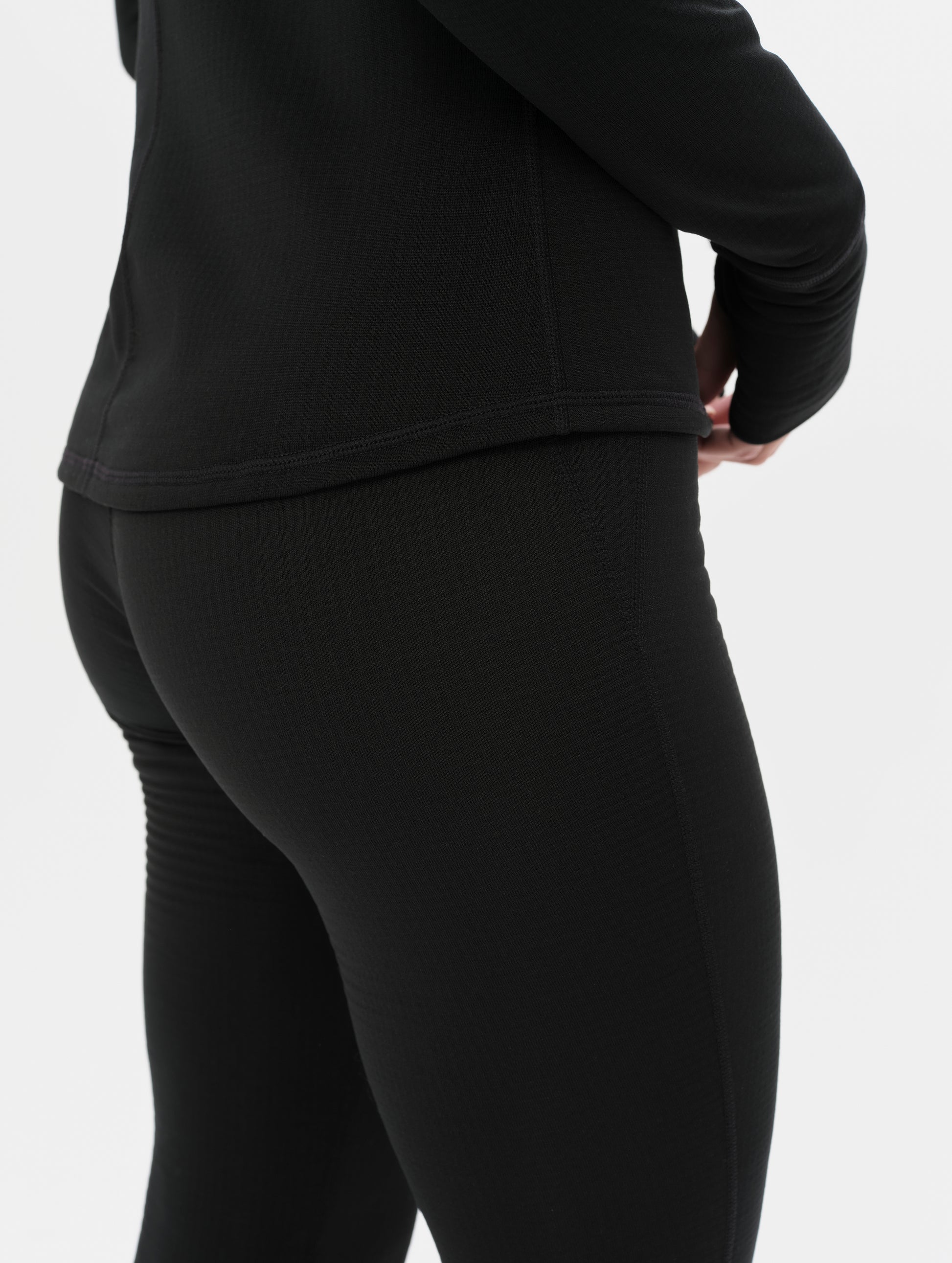 Side profile closeup view of the flat-lock side seams on the Polar Base Layer Pant in Onyx Black from AETHER Apparel.