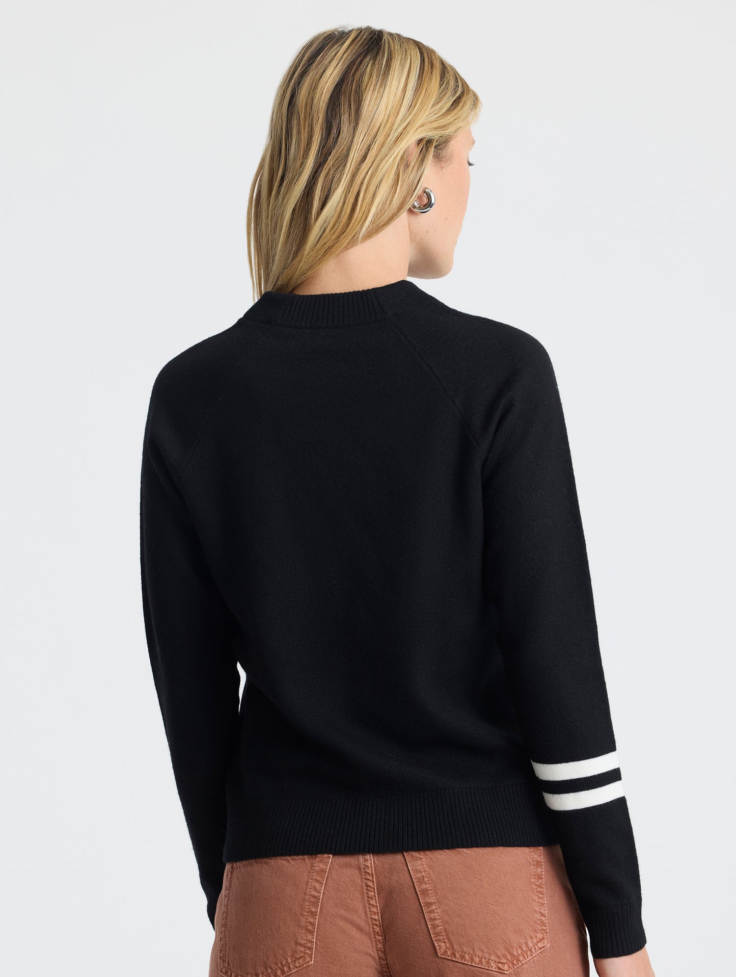 Rear view of woman wearing Racer Sweater 2.0 in Onyx Black from AETHER Apparel.