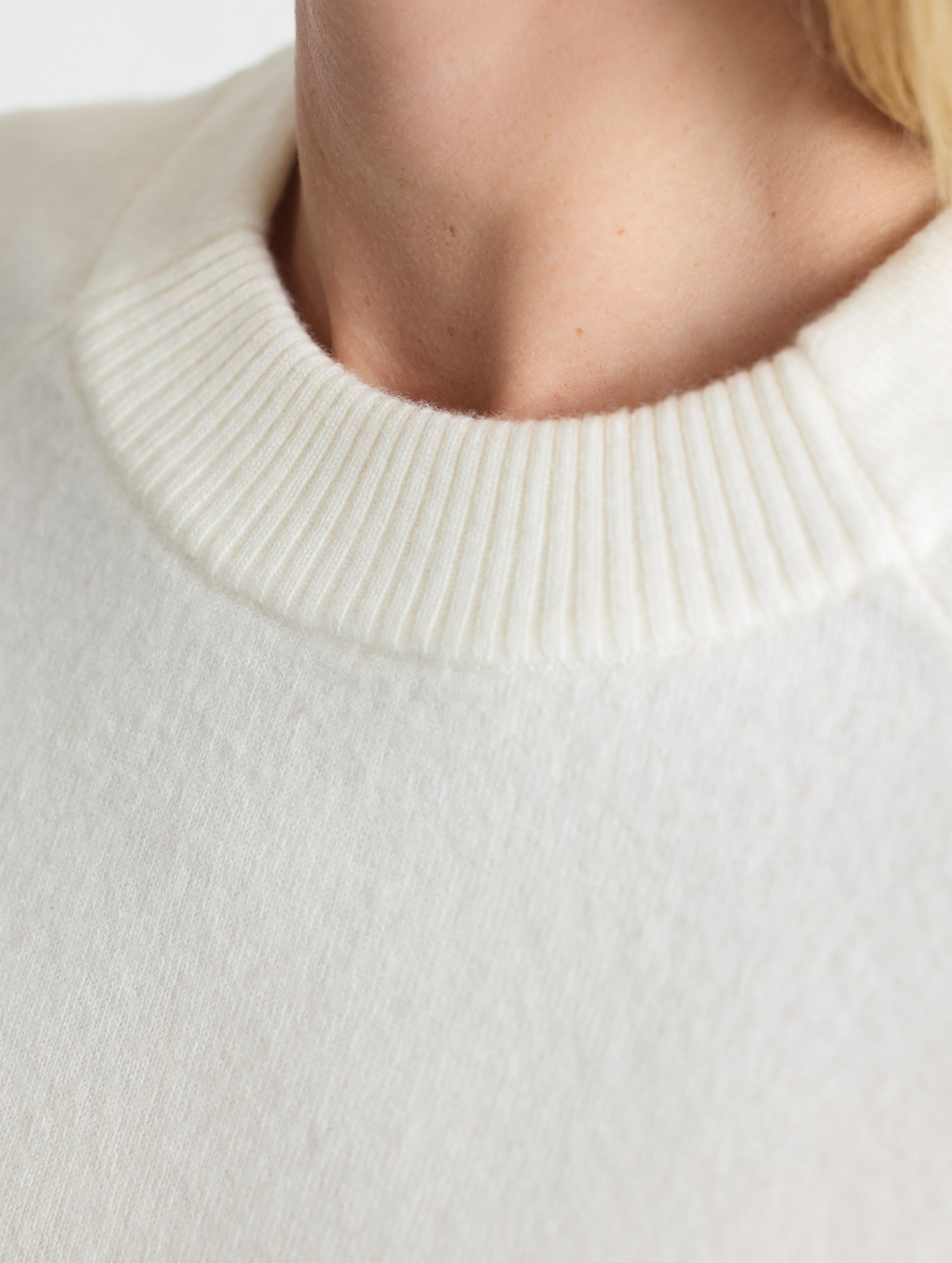 Closeup detailed view of collar of Racer Sweater 2.0 in Winter White from AETHER Apparel (product available in Onyx Black).