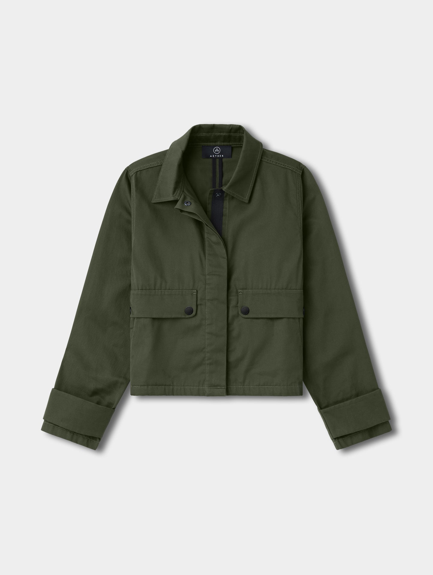 Flat lay view of the Raven Waxed Cotton Jacket in Forest Green from AETHER.