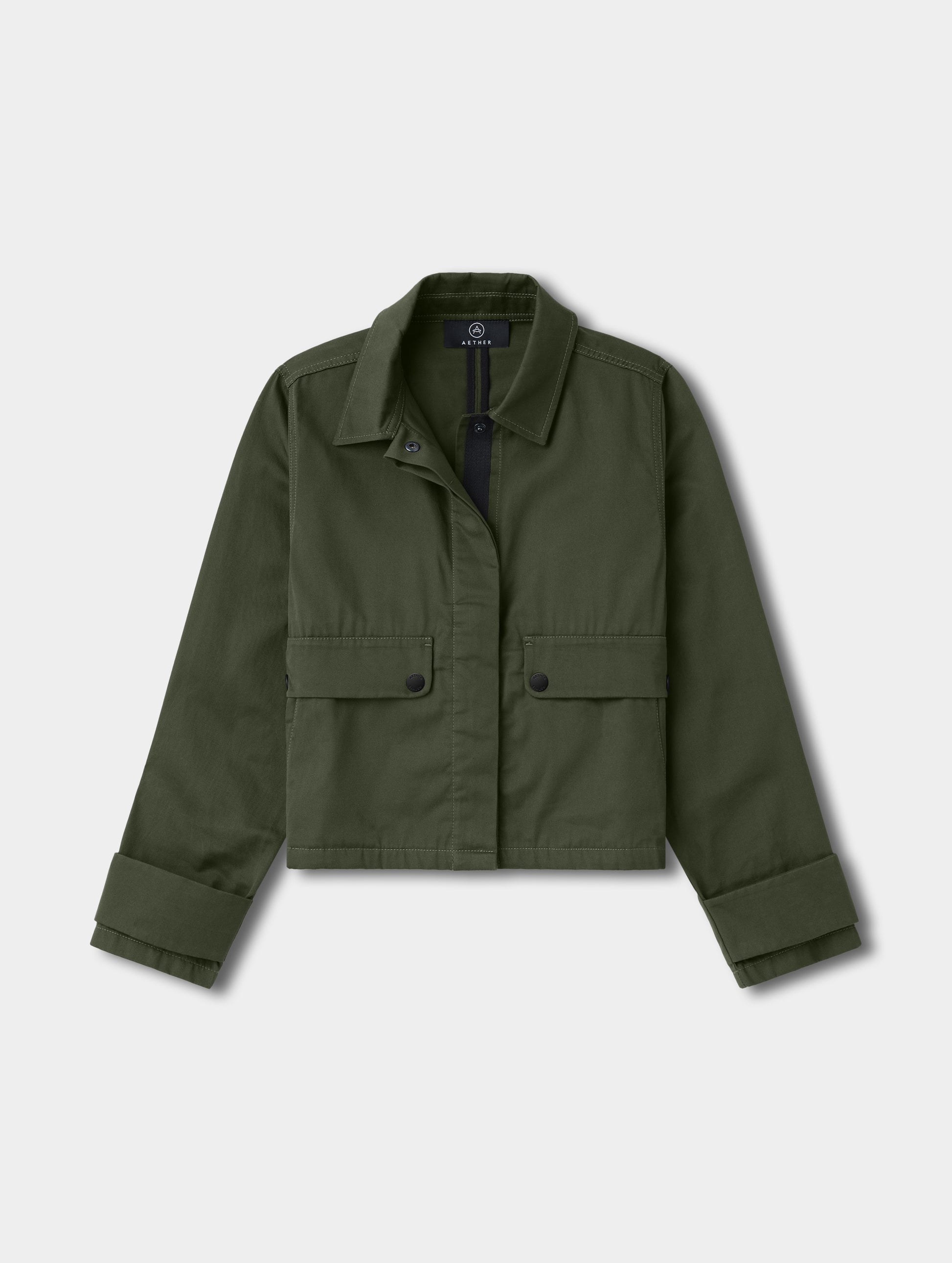 Flat lay view of the Raven Waxed Cotton Jacket in Forest Green from AETHER.
