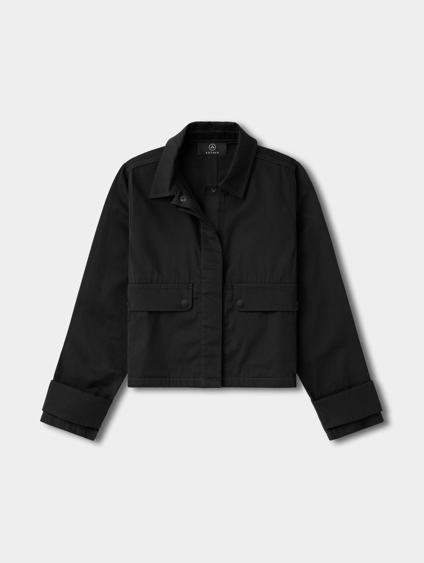 Flat lay view of the Raven Waxed Cotton Jacket in Onyx Black from AETHER.
