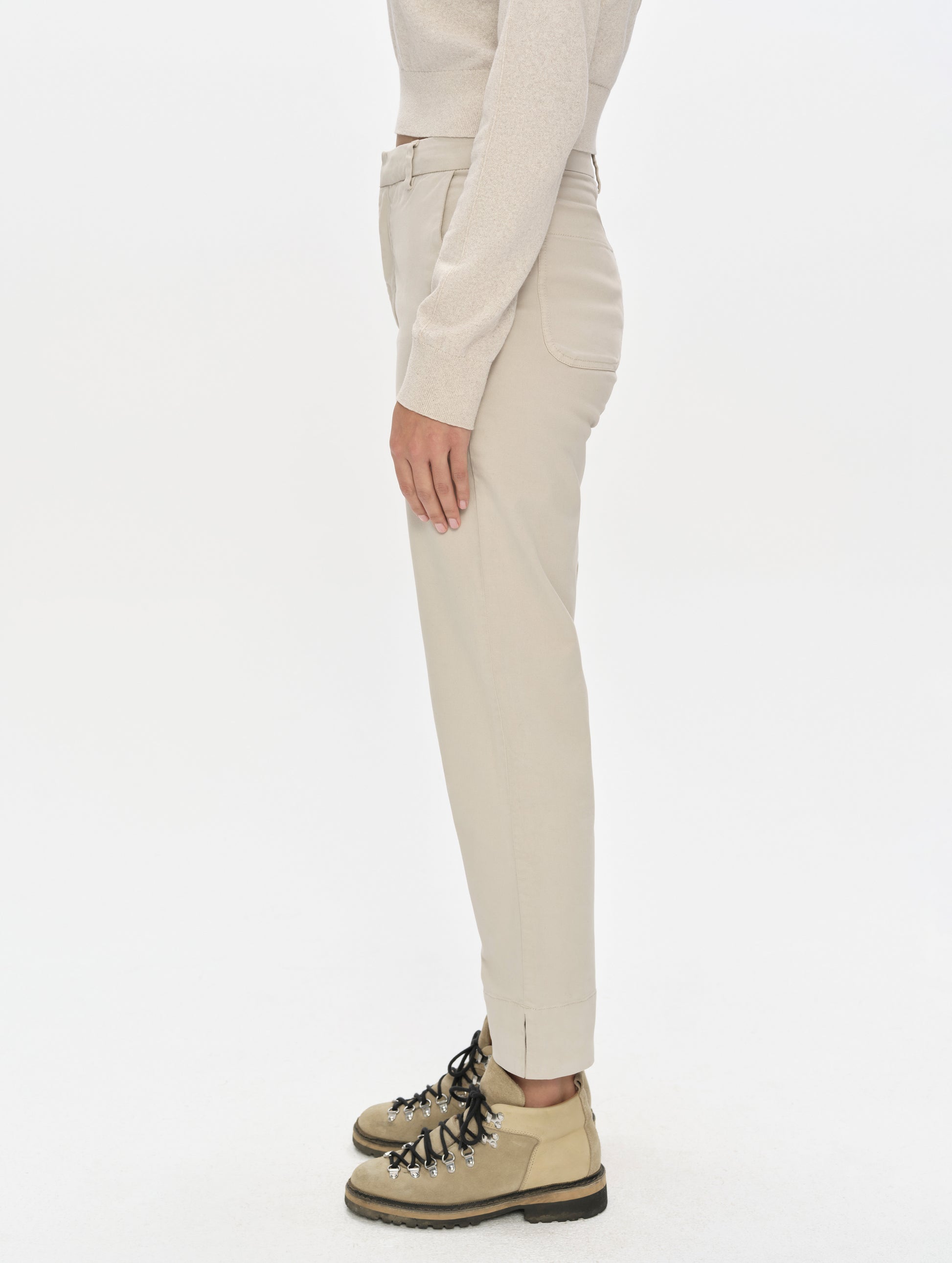 Side profile, lower-body view of woman wearing the Rhy Straight Leg Pant in Bone from AETHER Apparel.