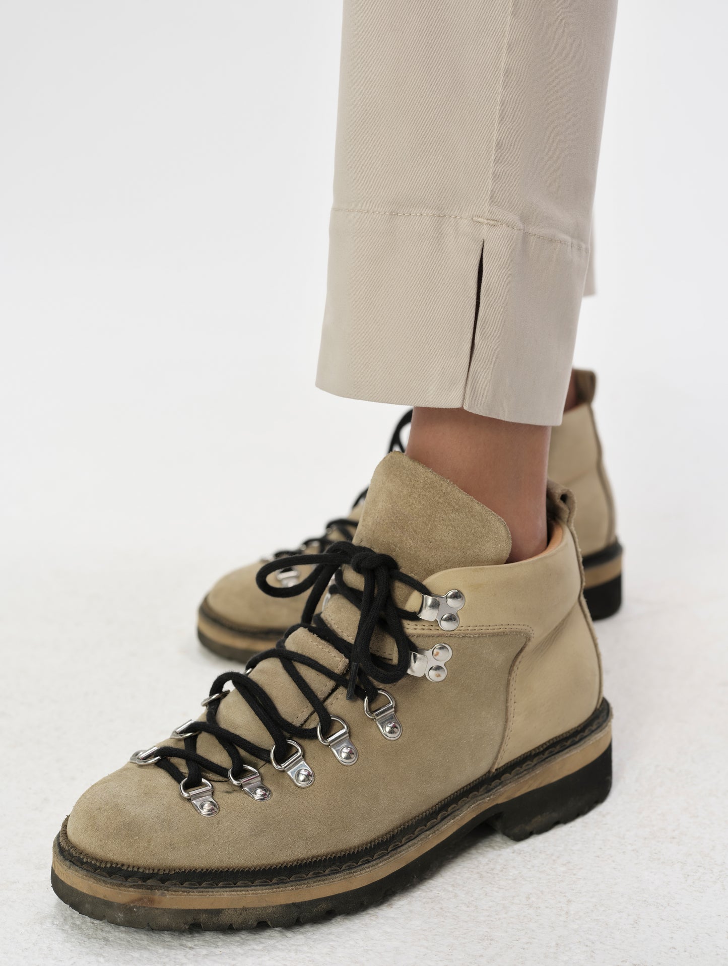Closeup detailed view of the split hem openings on the Rhy Straight Leg Pant in Bone from AETHER Apparel.