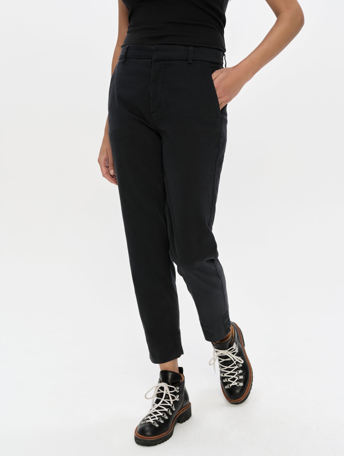 Front, 3/4, lower-body view of woman wearing the Rhy Straight Leg Pant in Onyx Black from AETHER Apparel.