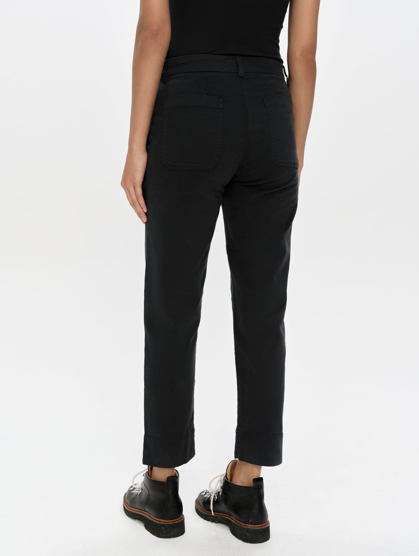 Rear, lower-body view of woman wearing the Rhy Straight Leg Pant in Onyx Black from AETHER Apparel.