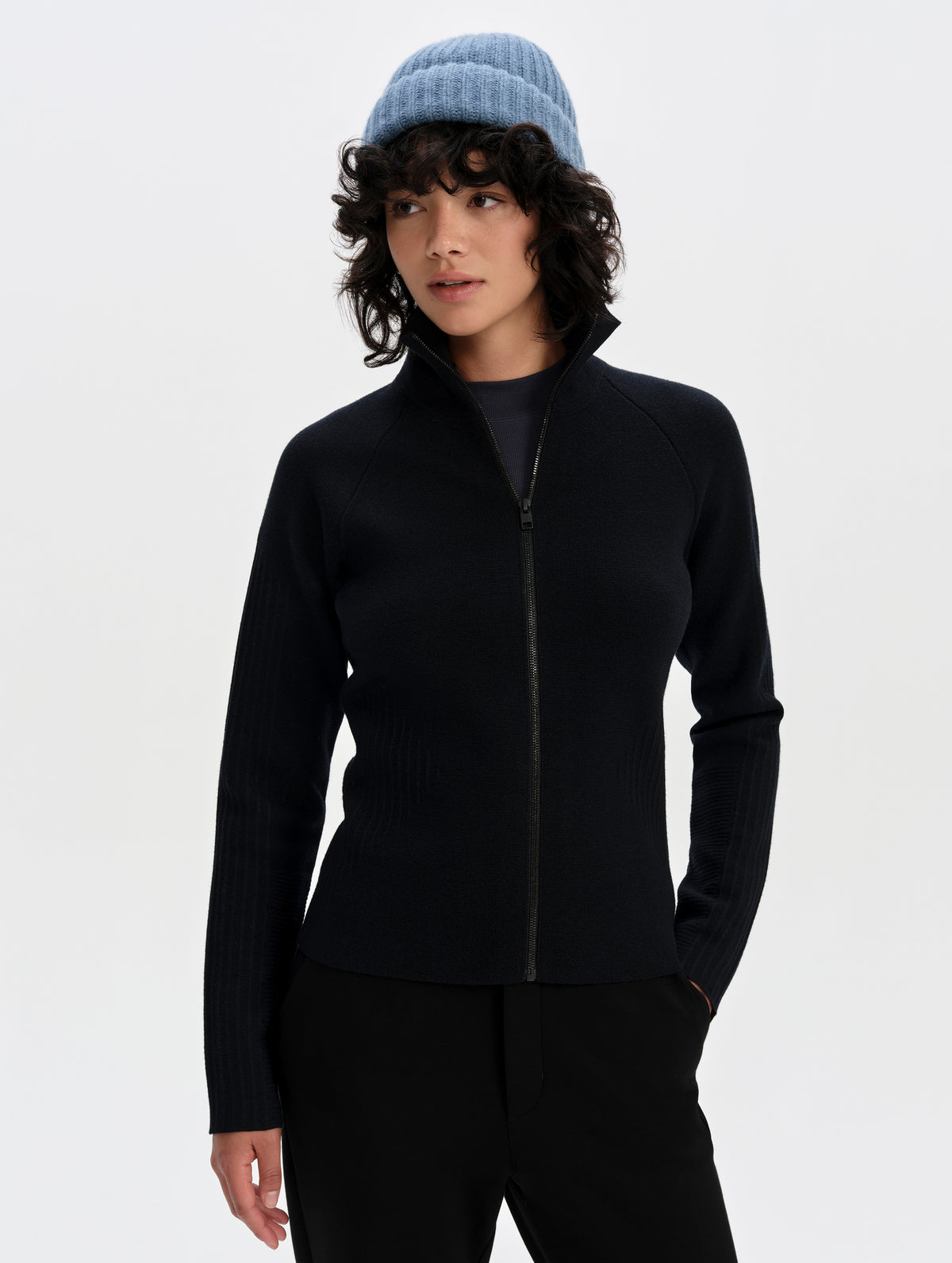 Front upper-body view of woman wearing the Riley Full-Zip Sweater 2.0 in Onyx Black from AETHER Apparel.