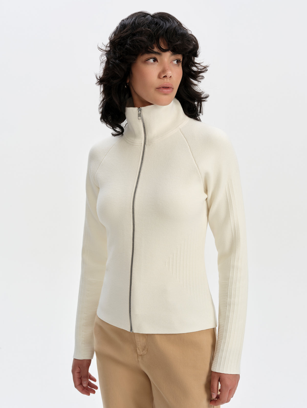 Front upper-body view of woman wearing the Riley Full-Zip Sweater 2.0 in Winter White from AETHER Apparel.