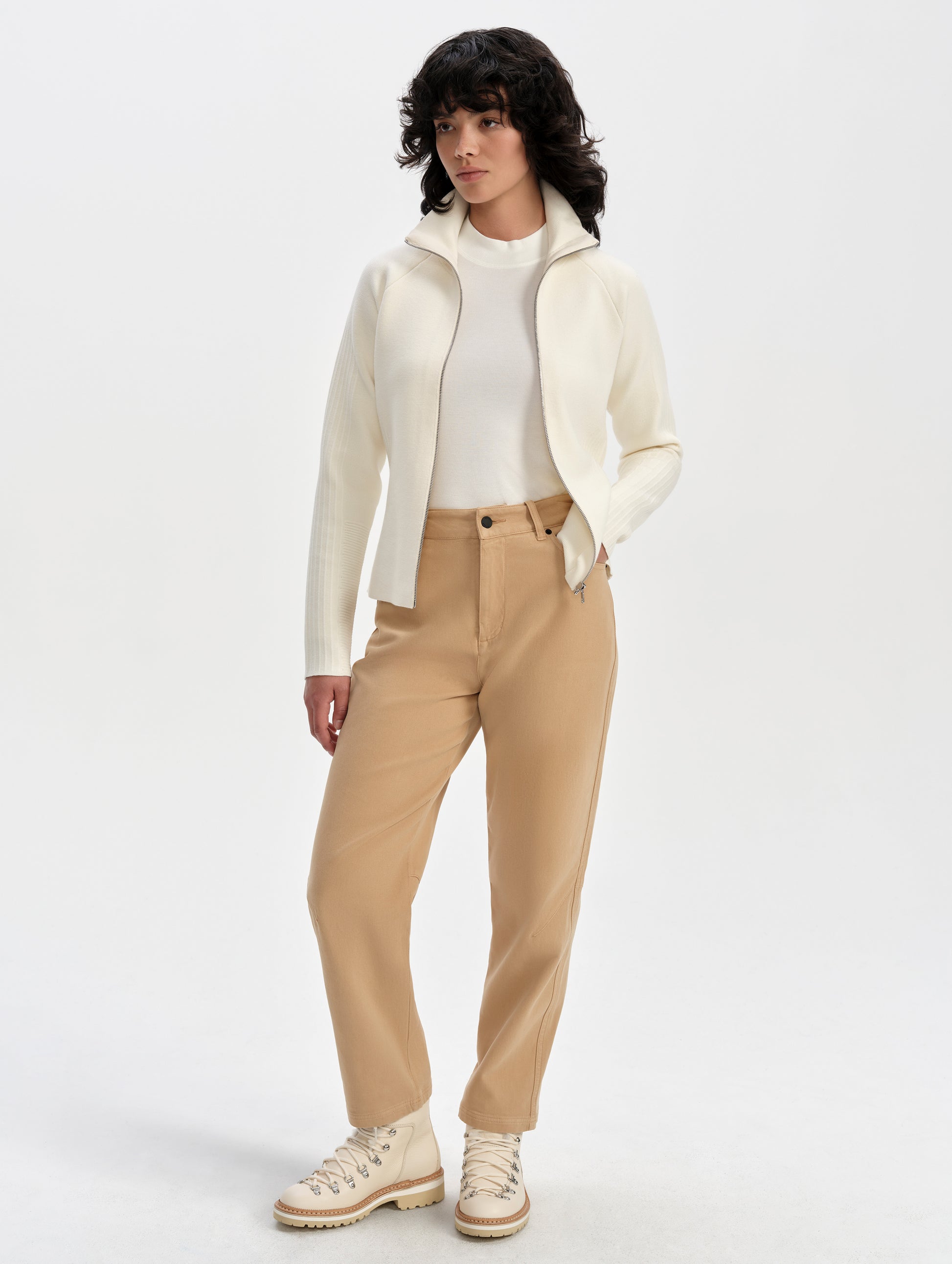 Front full-body view of woman wearing the Riley Full-Zip Sweater 2.0 in Winter White from AETHER Apparel.