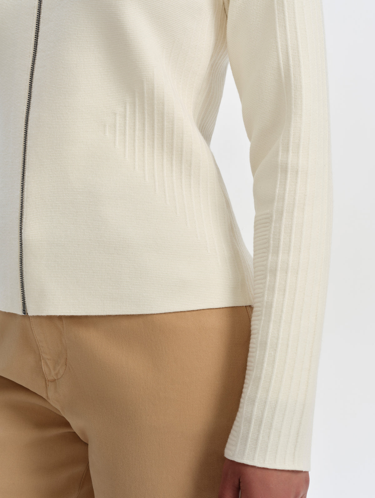 Closeup detailed view of the ottoman stitch details on the sides and sleeves of the Riley Full-Zip Sweater 2.0 in Winter White from AETHER Apparel.