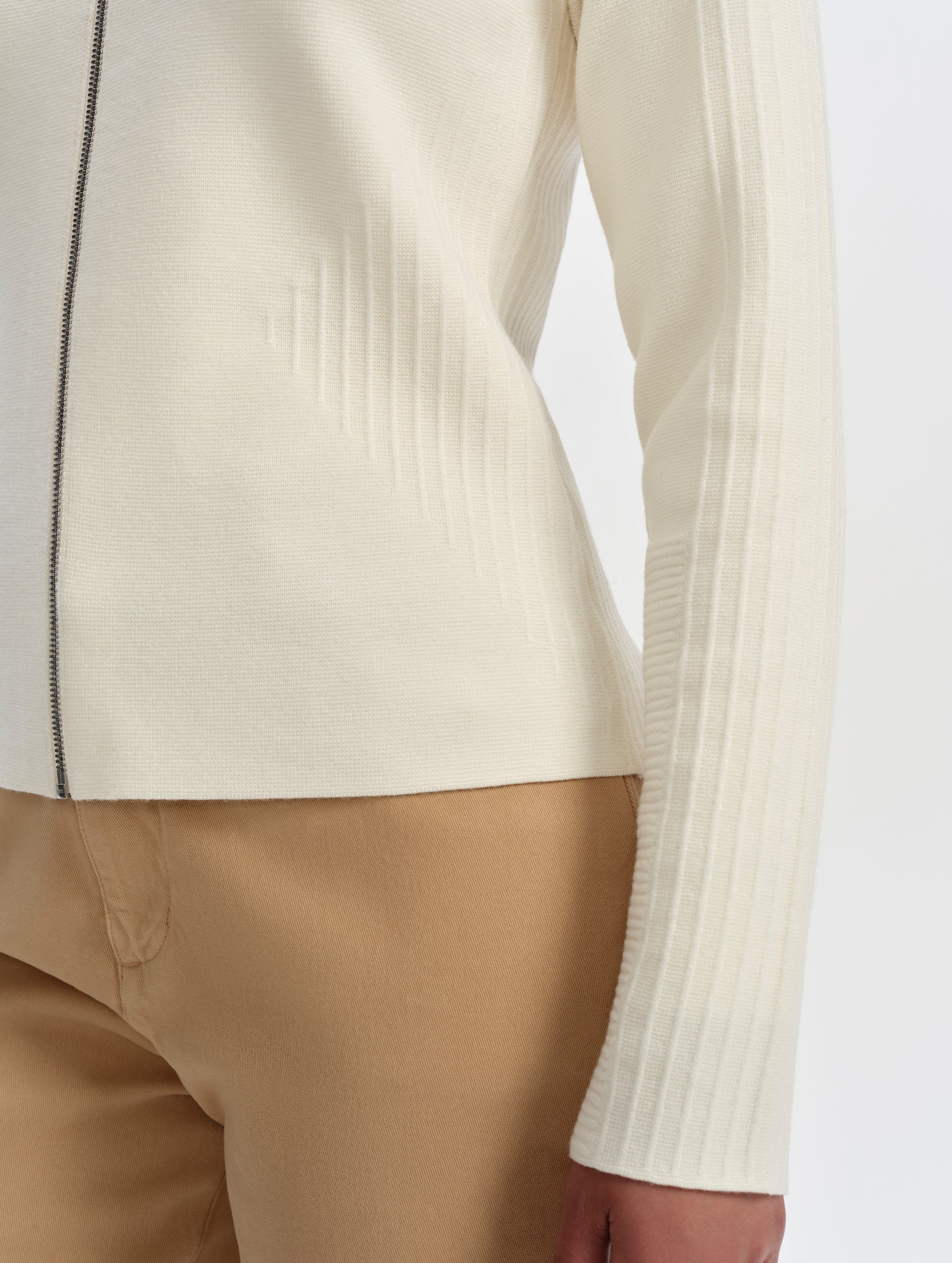 Closeup detailed view of the ottoman stitch details on the sides and sleeves of the Riley Full-Zip Sweater 2.0 in Winter White from AETHER Apparel.