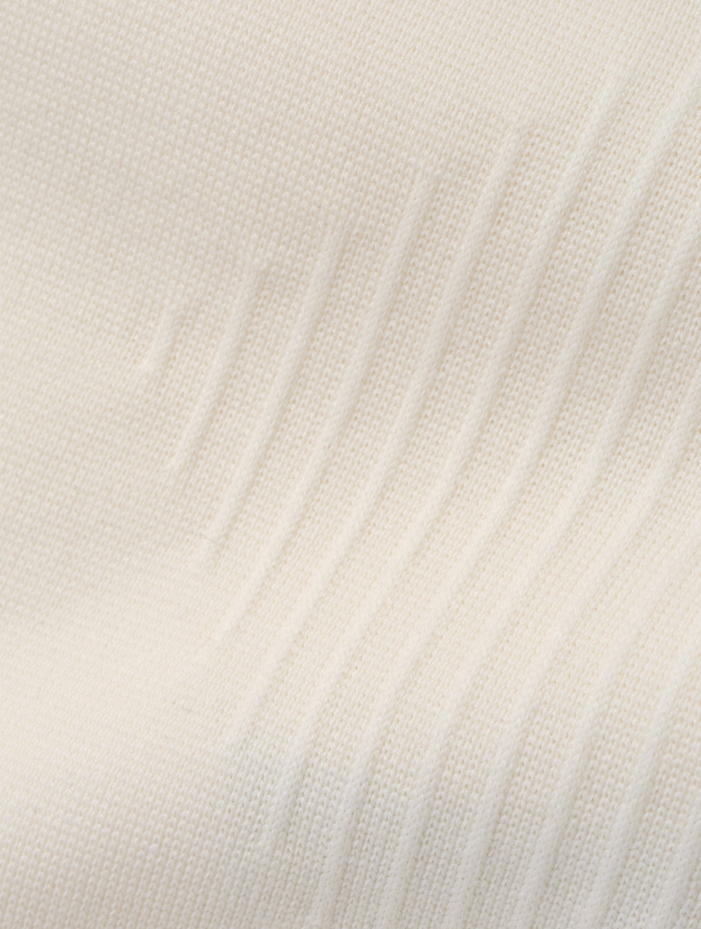 Closeup detailed view of the ottoman stitch details and knitted merino wool construction on the Riley Full-Zip Sweater 2.0 in Winter White from AETHER Apparel.