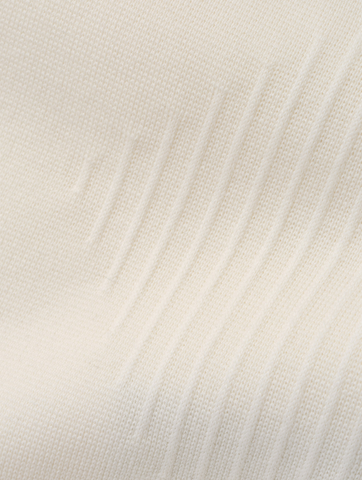 Closeup detailed view of the ottoman stitch details and knitted merino wool construction on the Riley Full-Zip Sweater 2.0 in Winter White from AETHER Apparel.