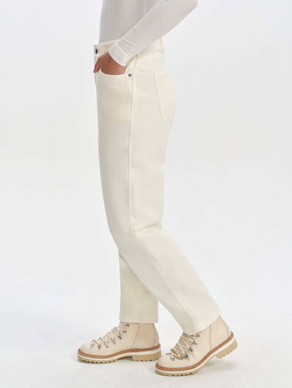 Side profile lower-body view of woman wearing the Rowan Cotton Pant in Winter White from AETHER Apparel.
