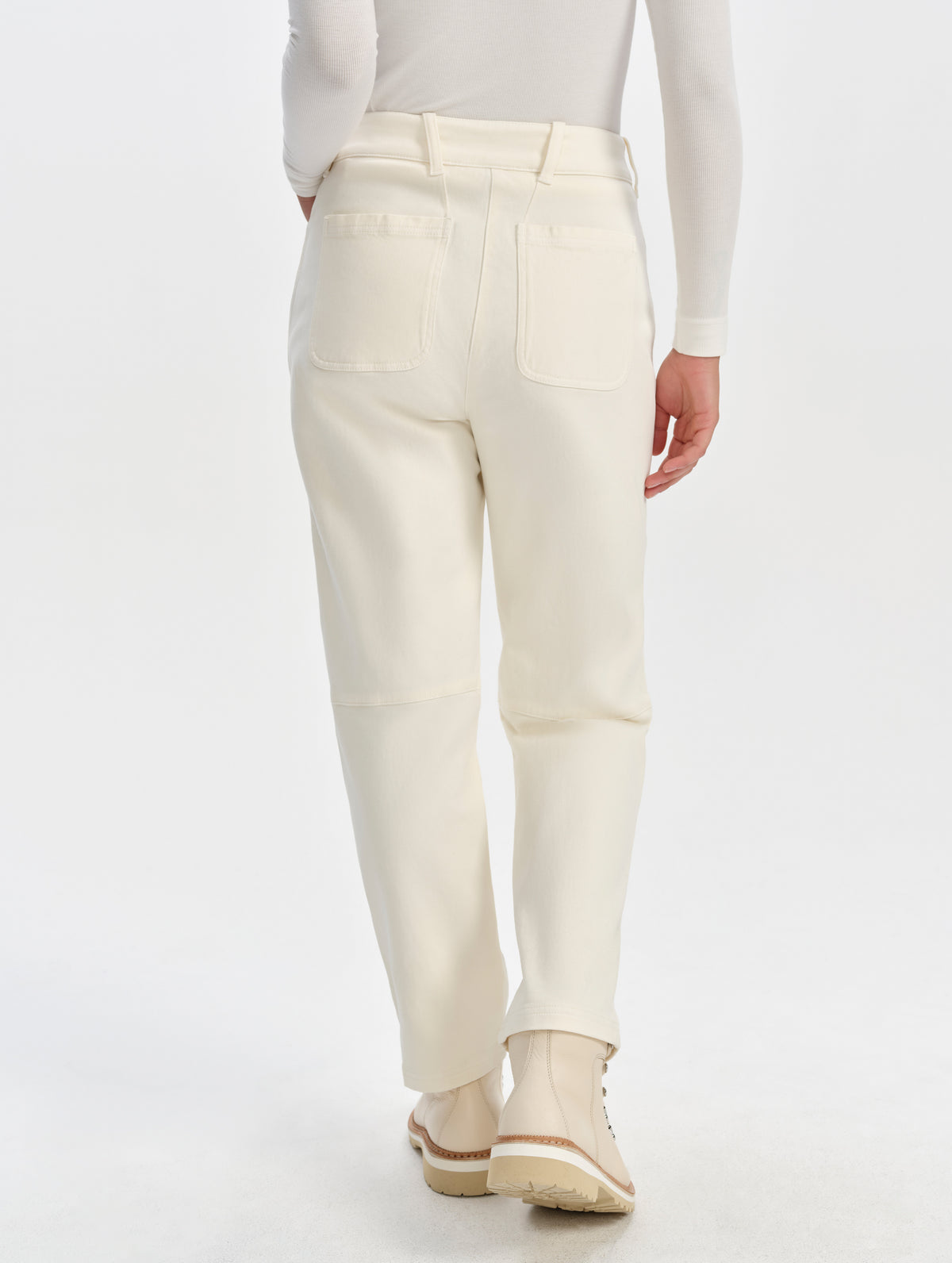 Rear lower-body view of woman wearing the Rowan Cotton Pant in Winter White from AETHER Apparel.
