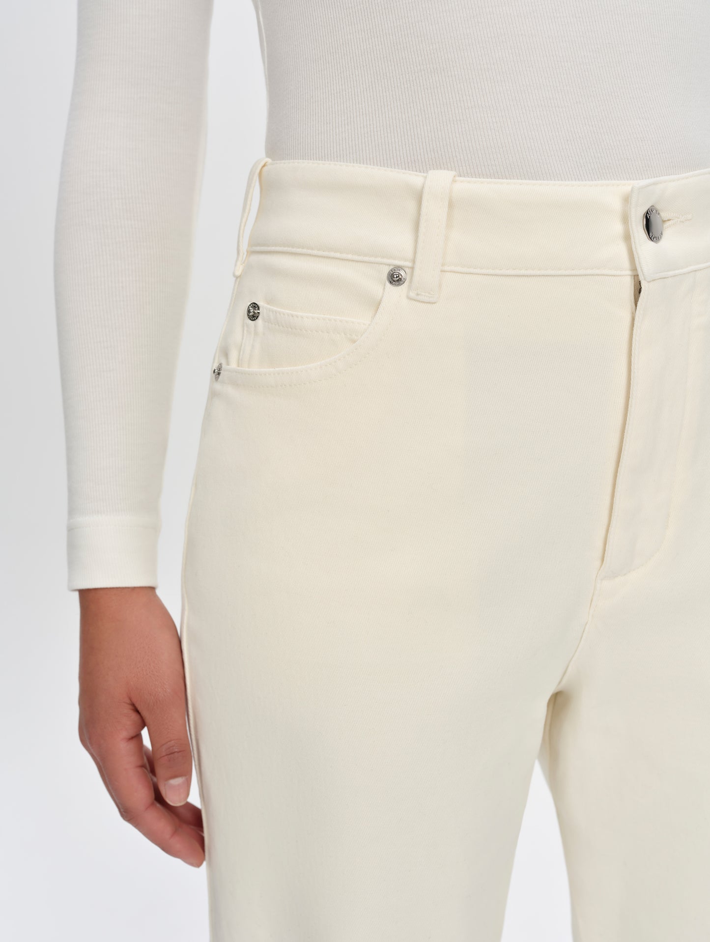 Closeup detailed view of the hand pockets, coin pocket, and belt loops on the Rowan Cotton Pant in Winter White from AETHER Apparel.