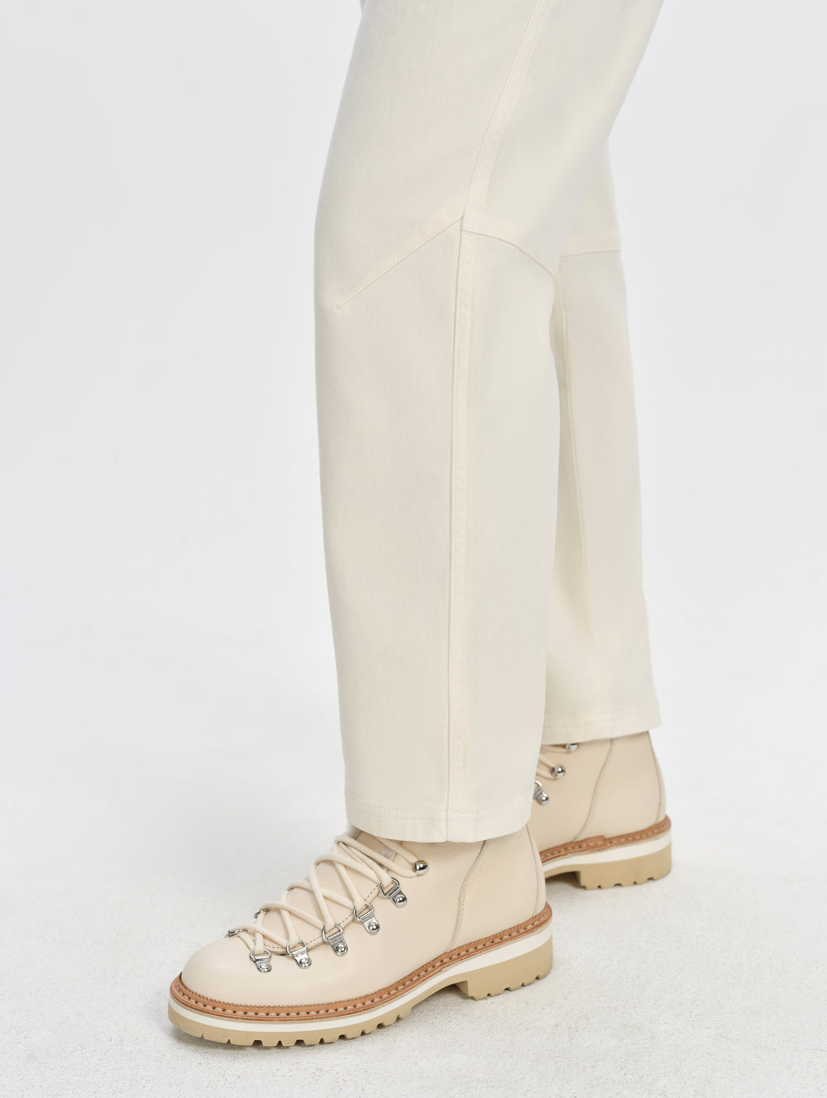Closeup detailed view of the pant legs and cuffs on the Rowan Cotton Pant in Winter White from AETHER Apparel.