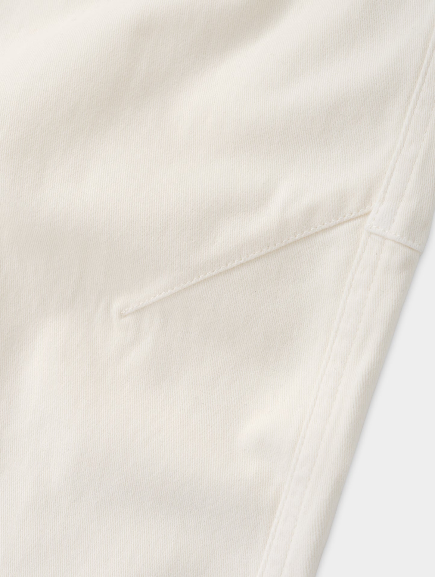 Closeup detailed view of the mobility-bolstering knee darts on the Rowan Cotton Pant in Winter White from AETHER Apparel.