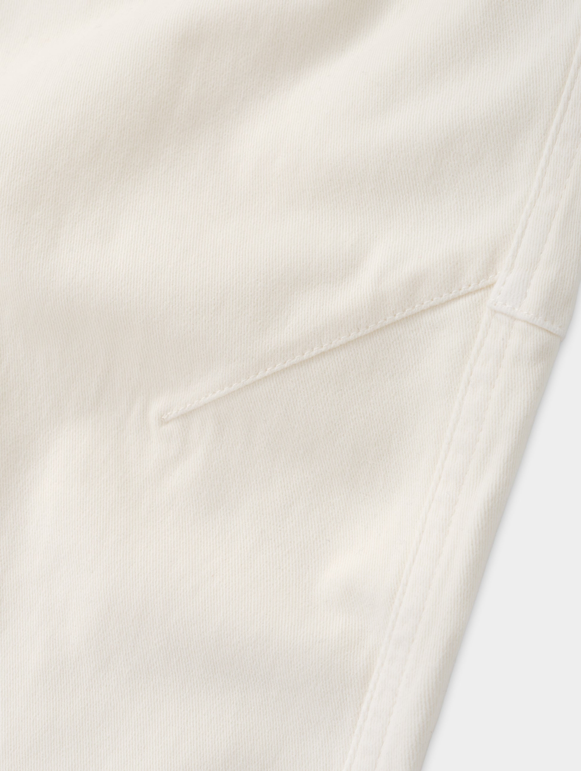 Closeup detailed view of the mobility-bolstering knee darts on the Rowan Cotton Pant in Winter White from AETHER Apparel.