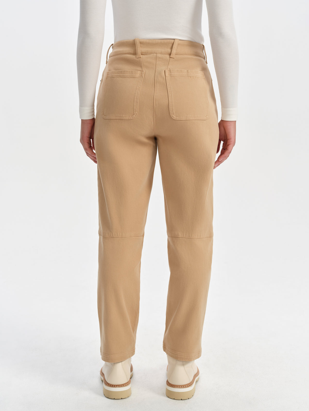 Rear lower-body view of woman wearing the Rowan Cotton Pant in Latte Brown from AETHER Apparel.