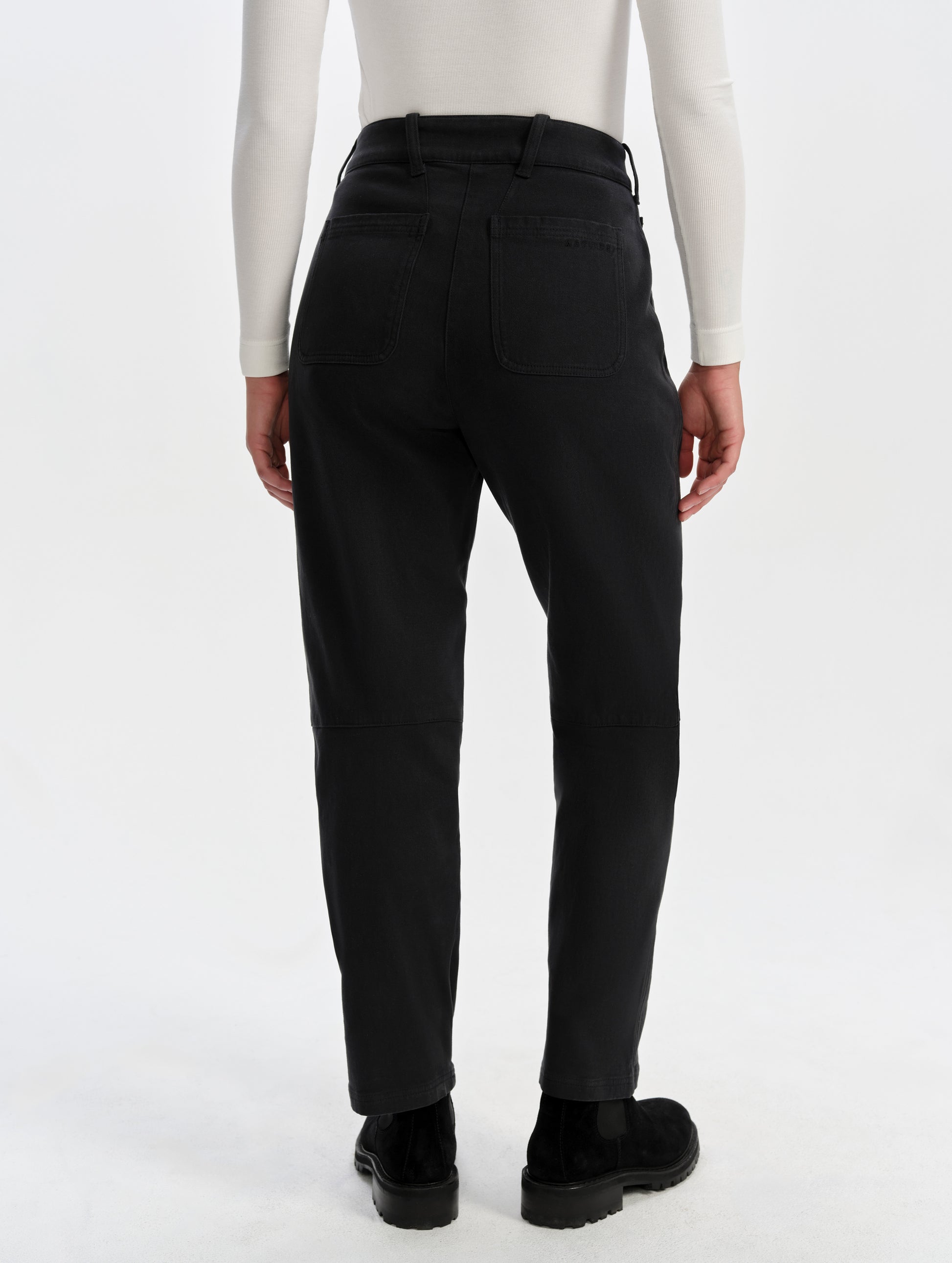 Rear lower-body view of woman wearing the Rowan Cotton Pant in Onyx Black from AETHER Apparel.