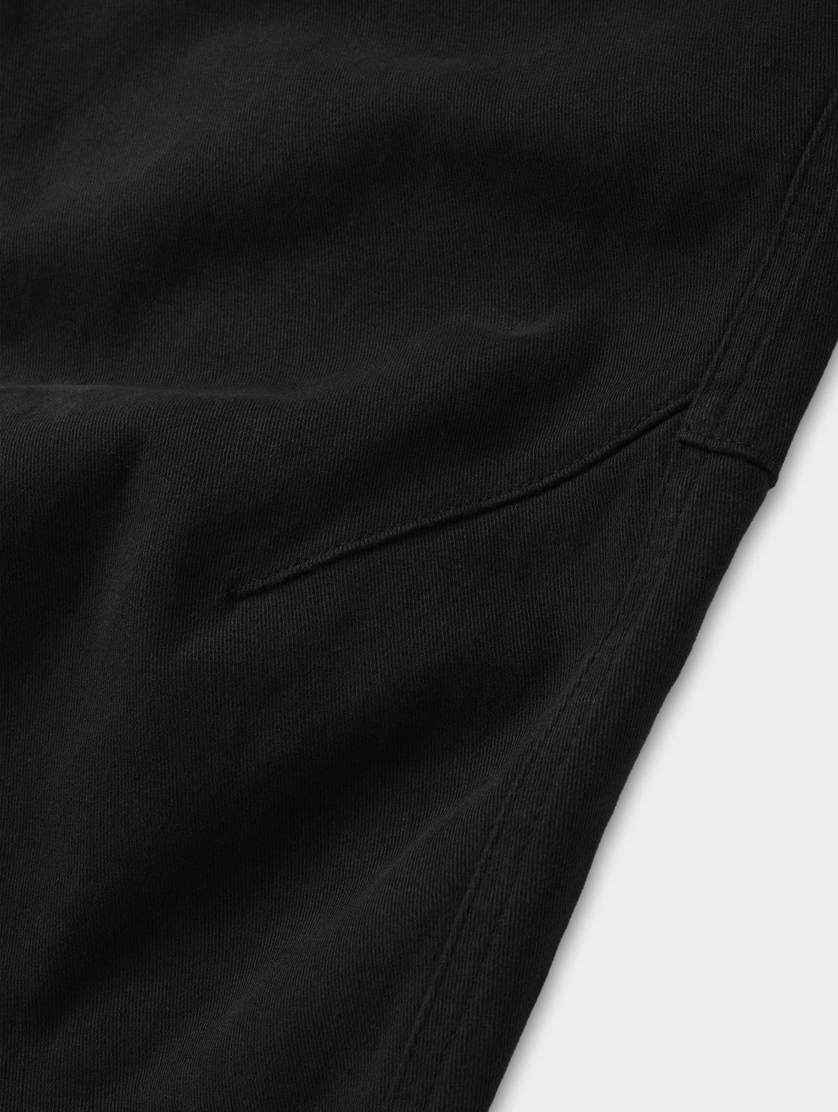 Closeup detailed view of the mobility-bolstering knee darts on the Rowan Cotton Pant in Onyx Black from AETHER Apparel.